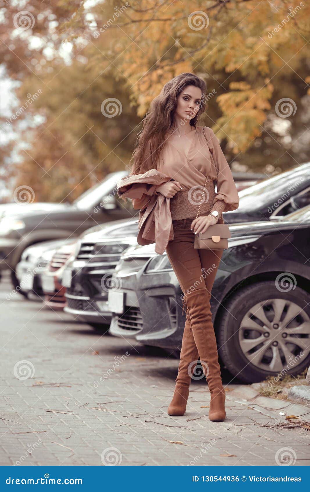 attractive woman in autumn style trendy outfit walking in street