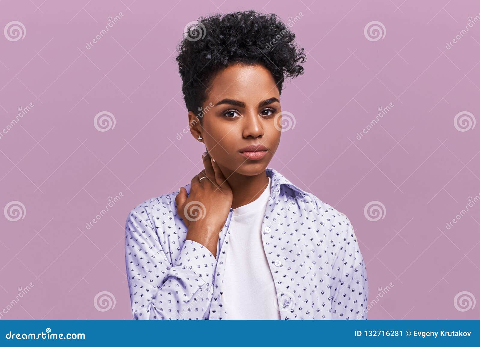 Premium Photo  Photo of confident woman has bushy afro hairstyle points  both index fingers above dressed in white jumper stands against brown  background advertises some item shows direction come upstairs