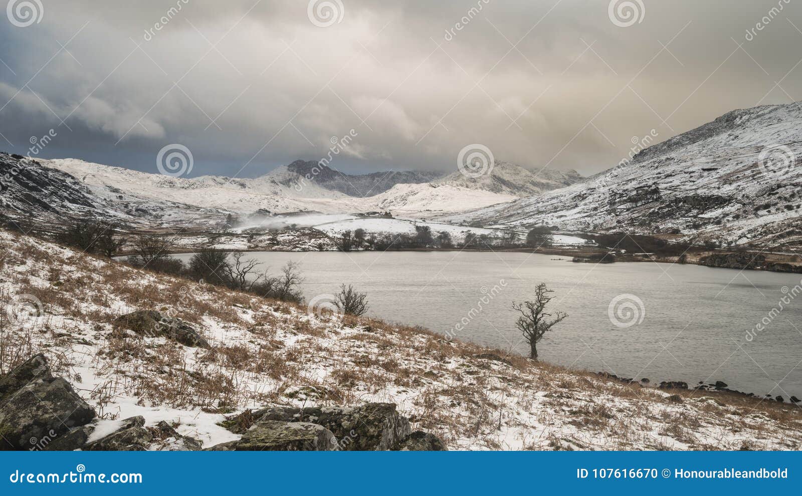 beautiful winter landscape image of llynnau mymbyr in snowdonia