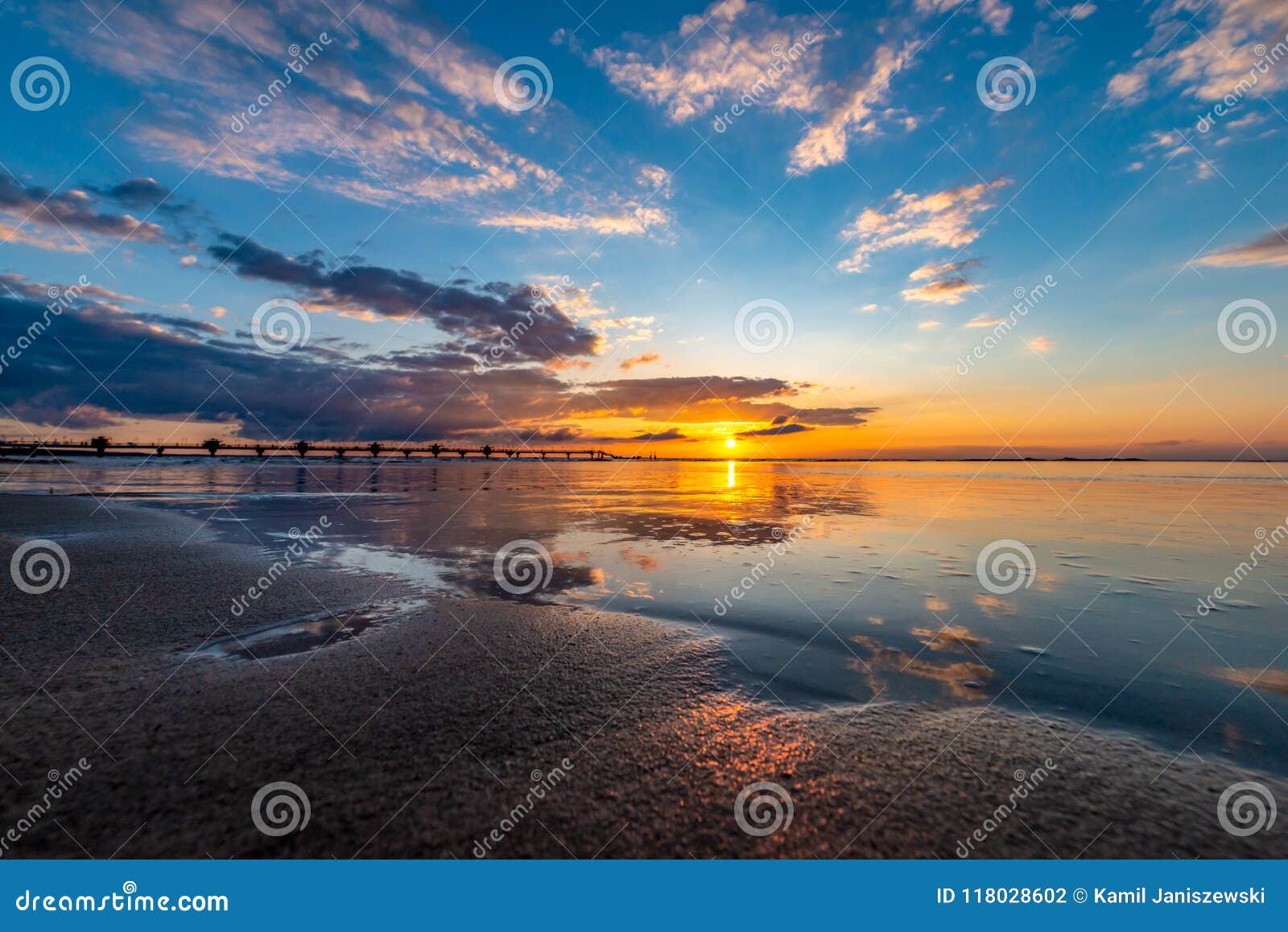 a beautiful sunset on the beach in miedzyzdroje