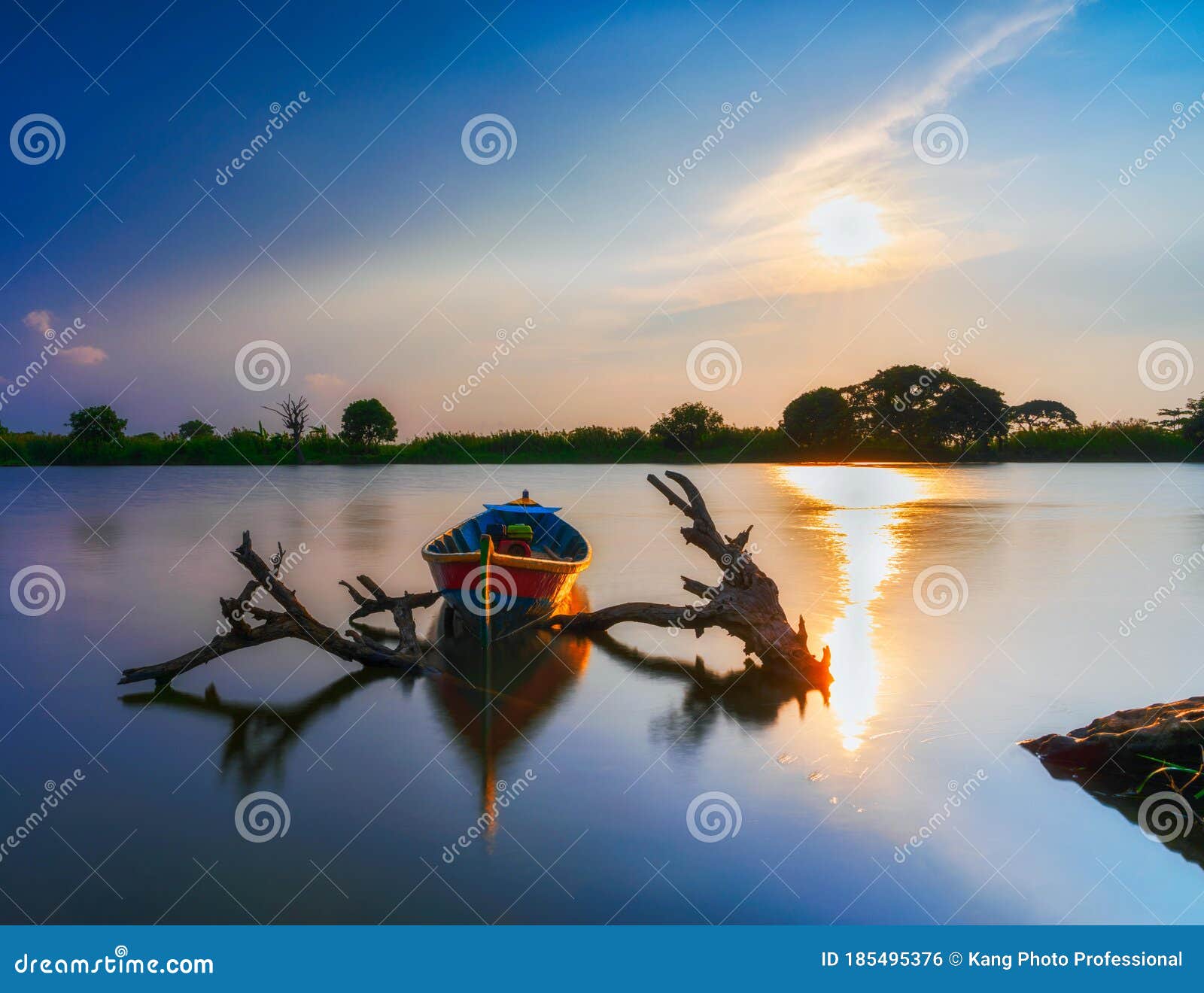 beautiful sunset in the lake with classic fishing boat in indonesia