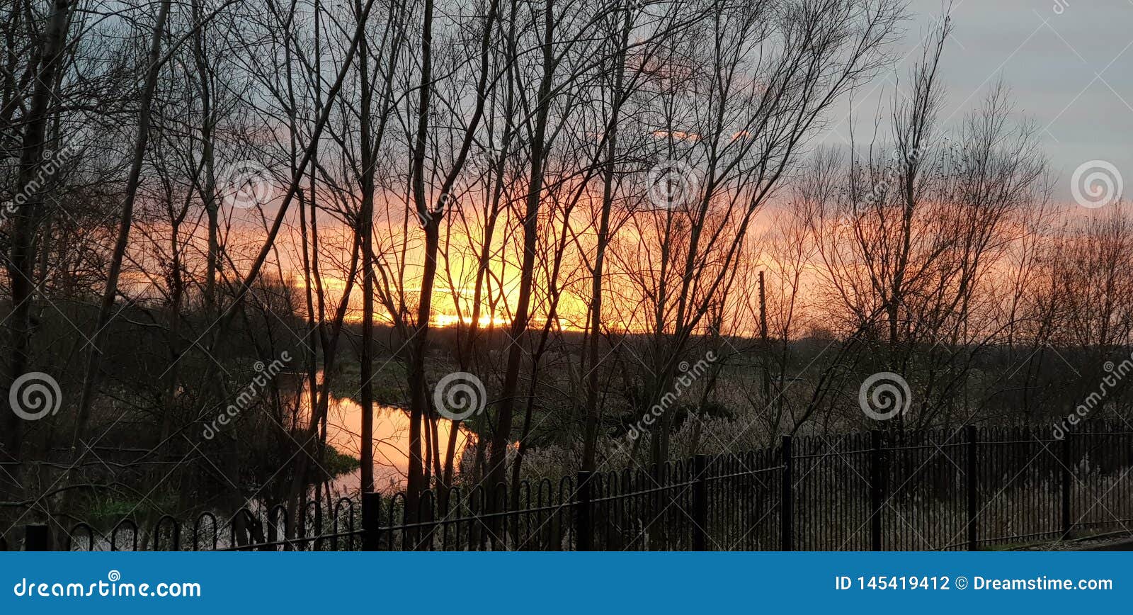 beautiful sunset in olney milton keynes over the river ouse with orange red and pink sky