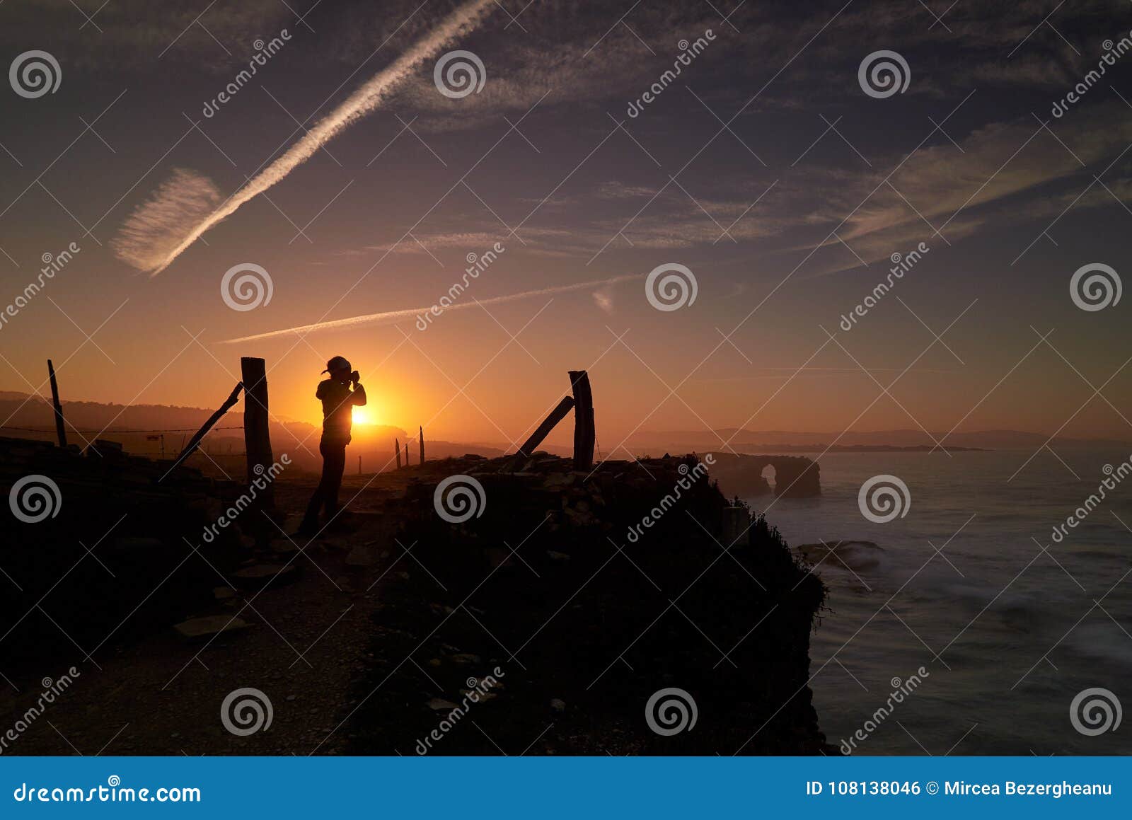 beautiful sunset and stone arches on playa de las catedrales during inflow spain