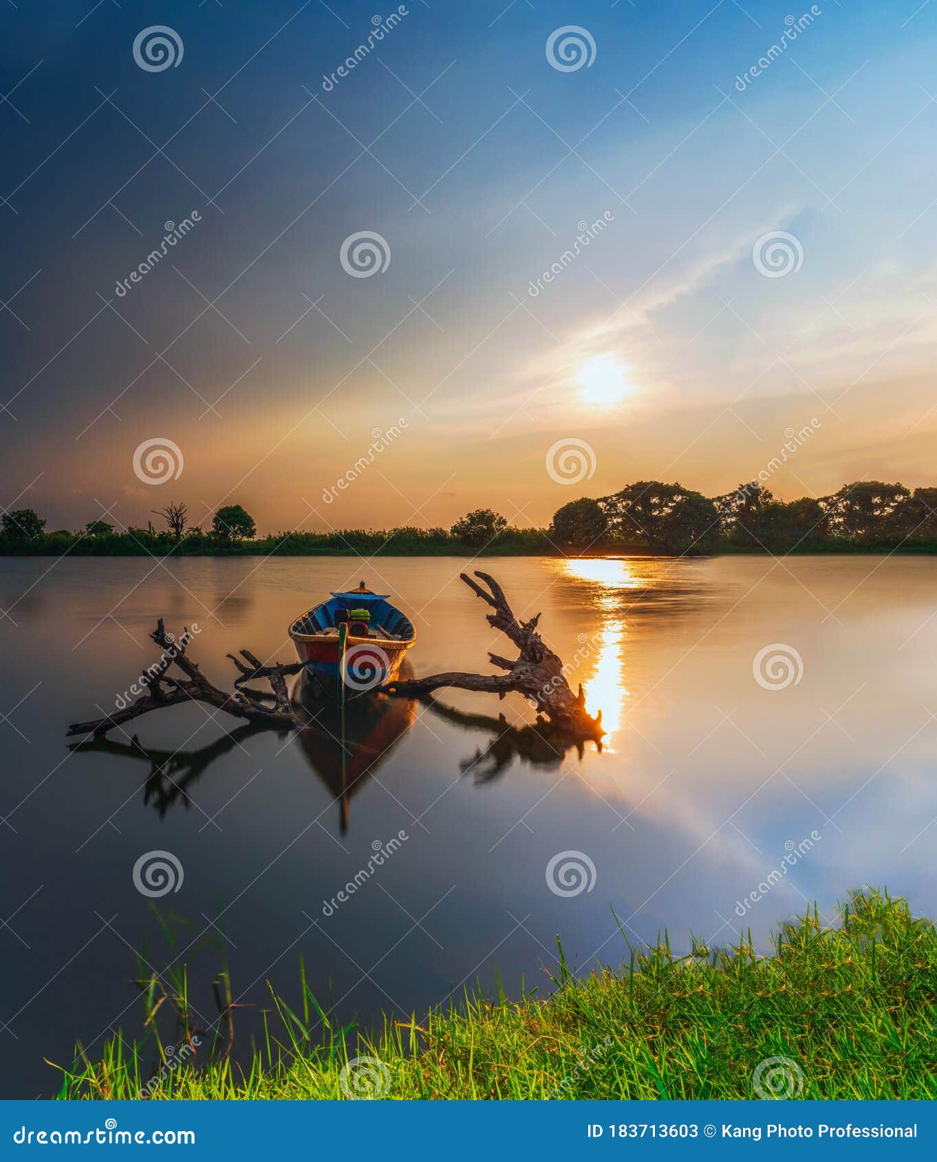 beautiful sunset and traditional beautiful little fishing boat with fantastic golden sky and nature