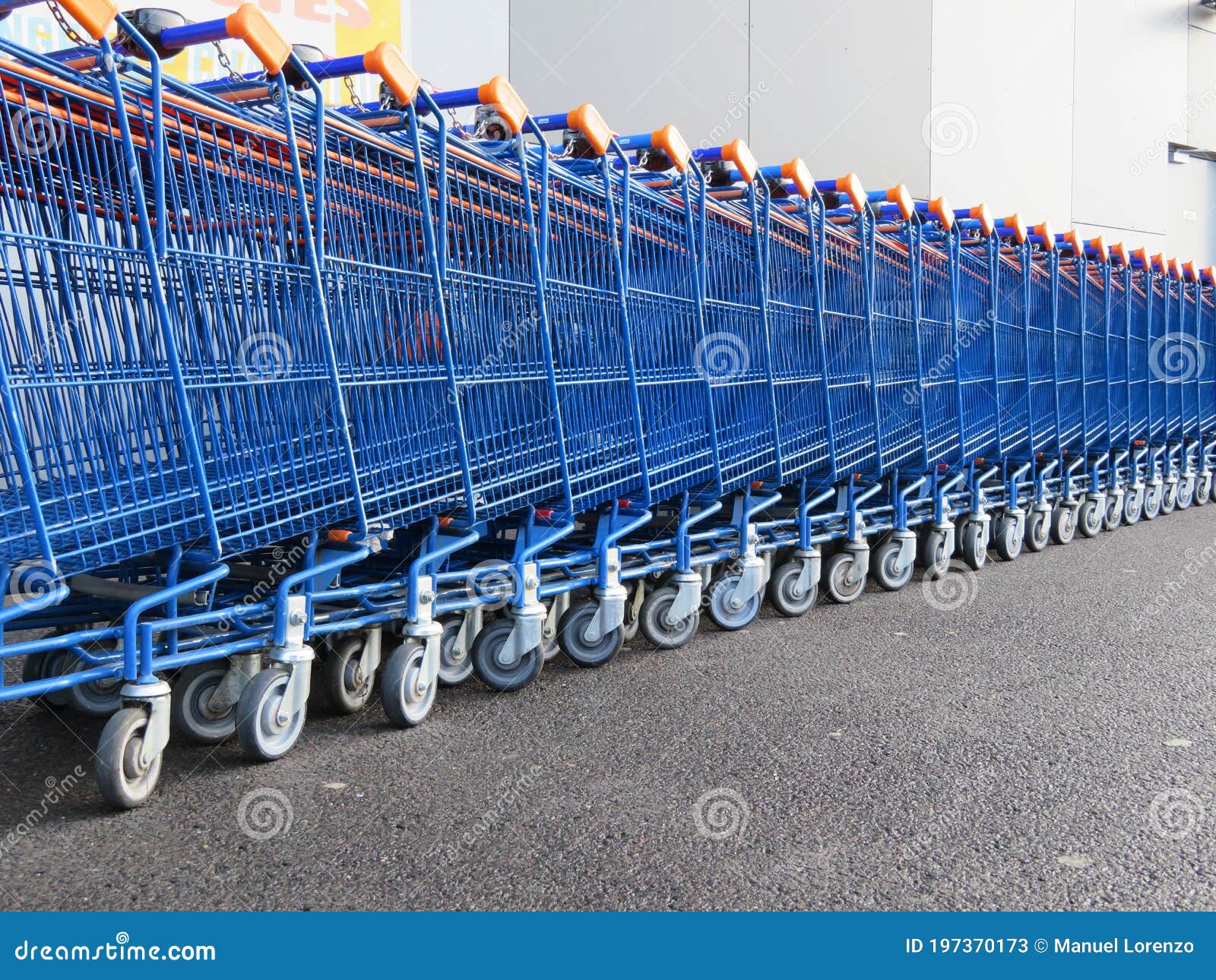 beautiful supermarket carts piled up in line waiting to be caught to transport goods