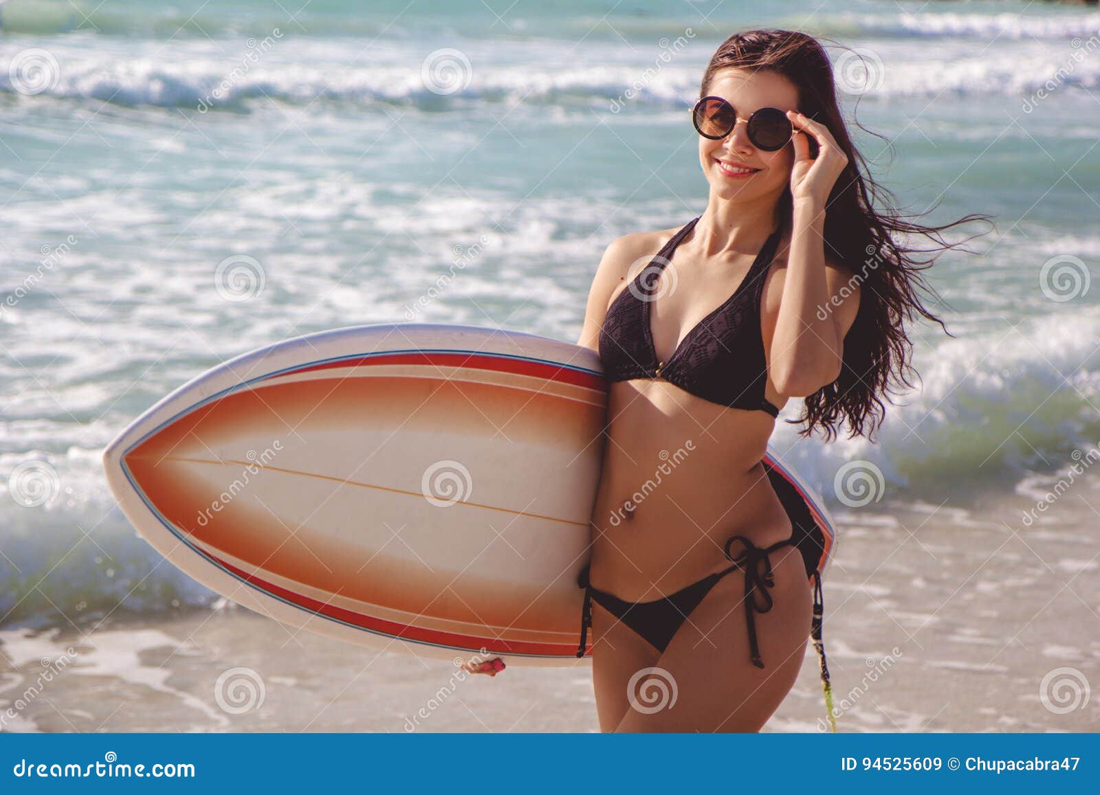 Beautiful Surfer Brunette Girl On The Beach At Sunset Time