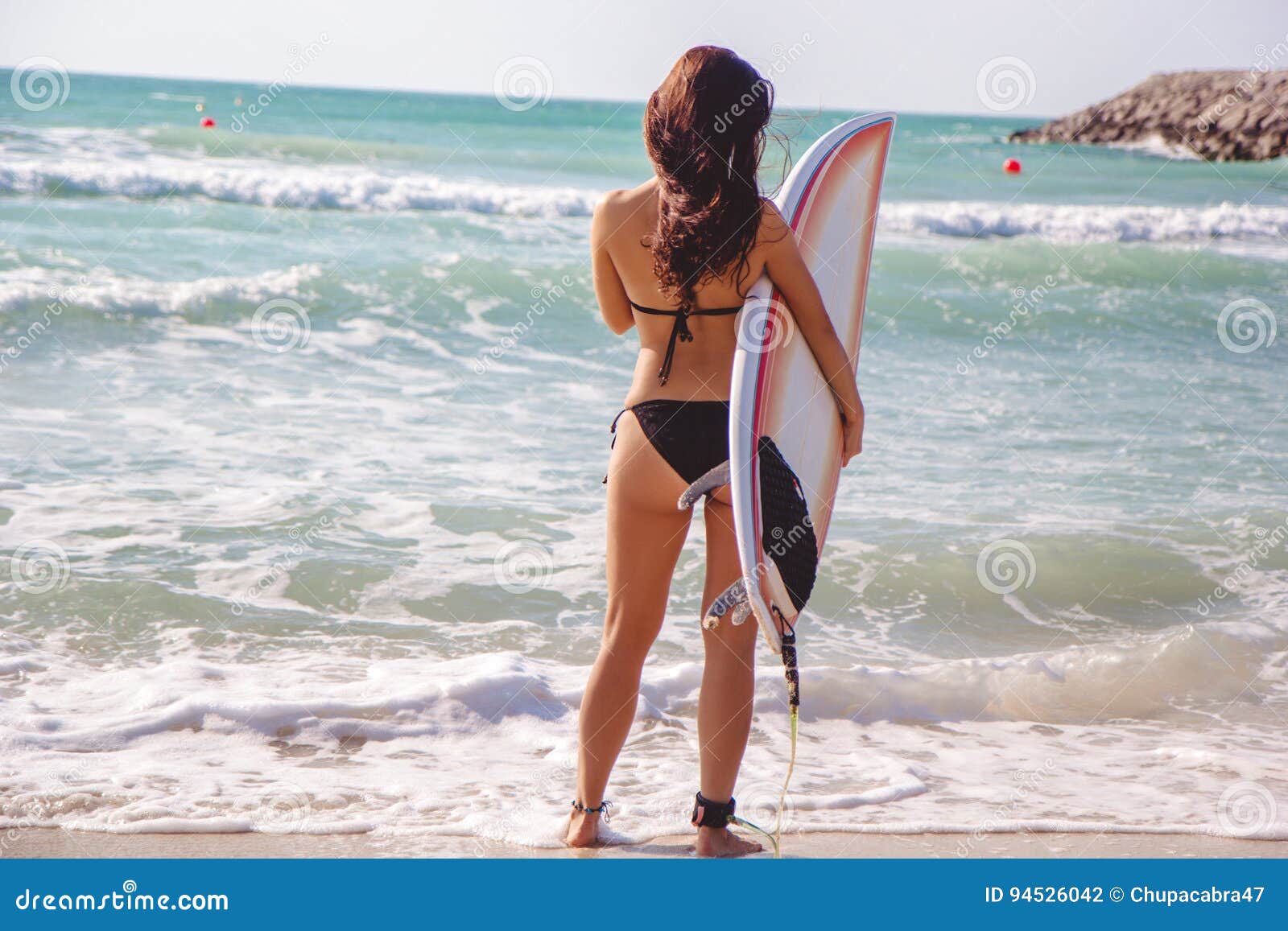 Beautiful Surfer Brunette Girl On The Beach At Sunset Time