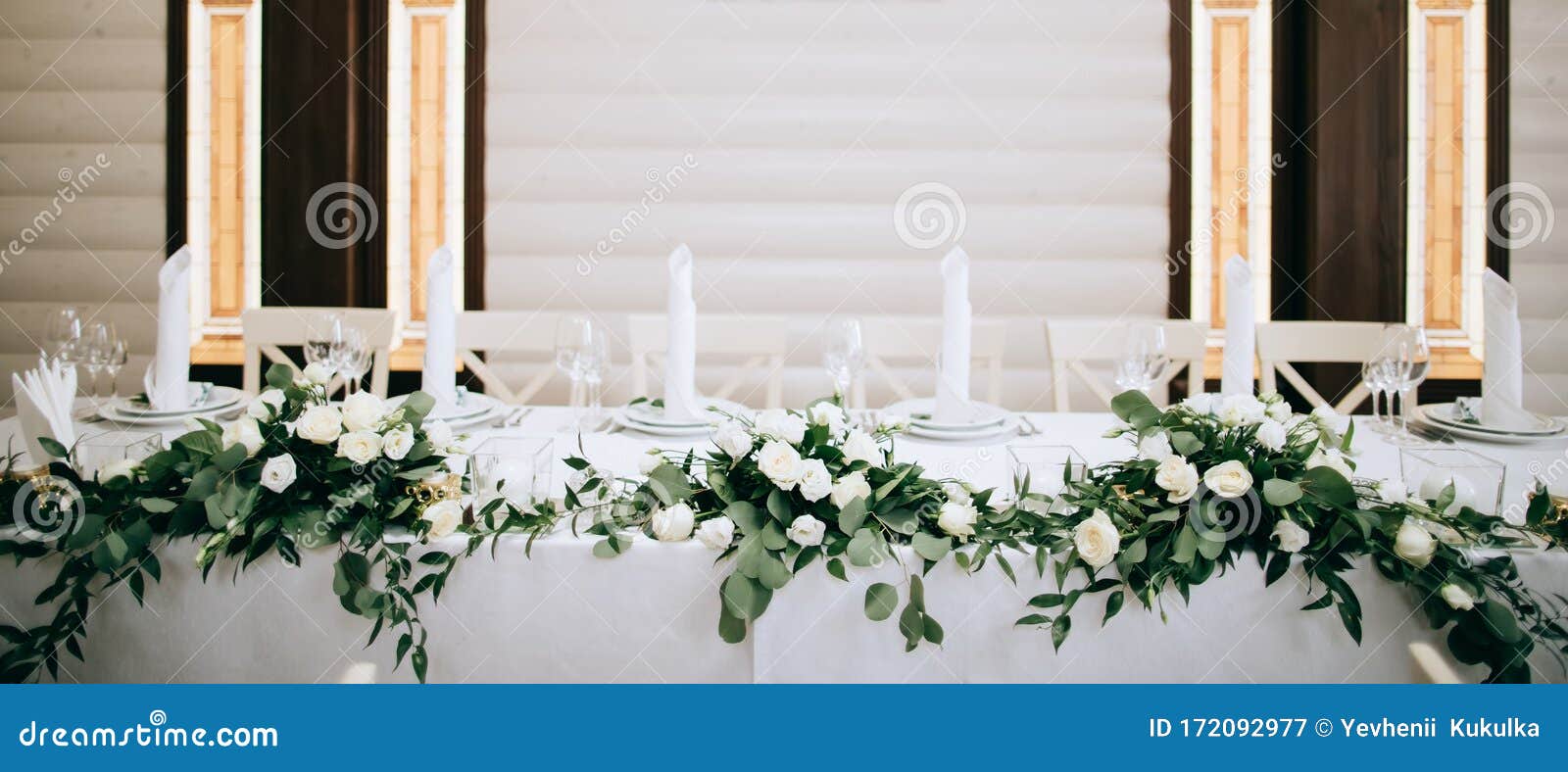 Beautiful Table Decoration with Green Leaves and Gold Candlesticks