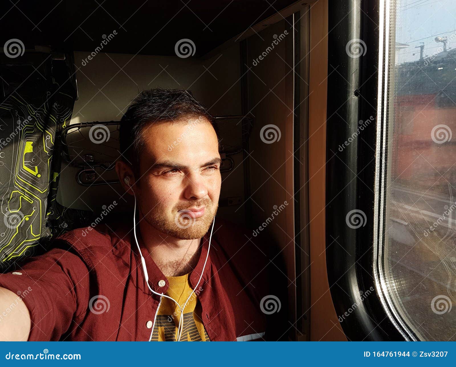 Young Man Looking Out Of Train Window Stock Photo - Download Image