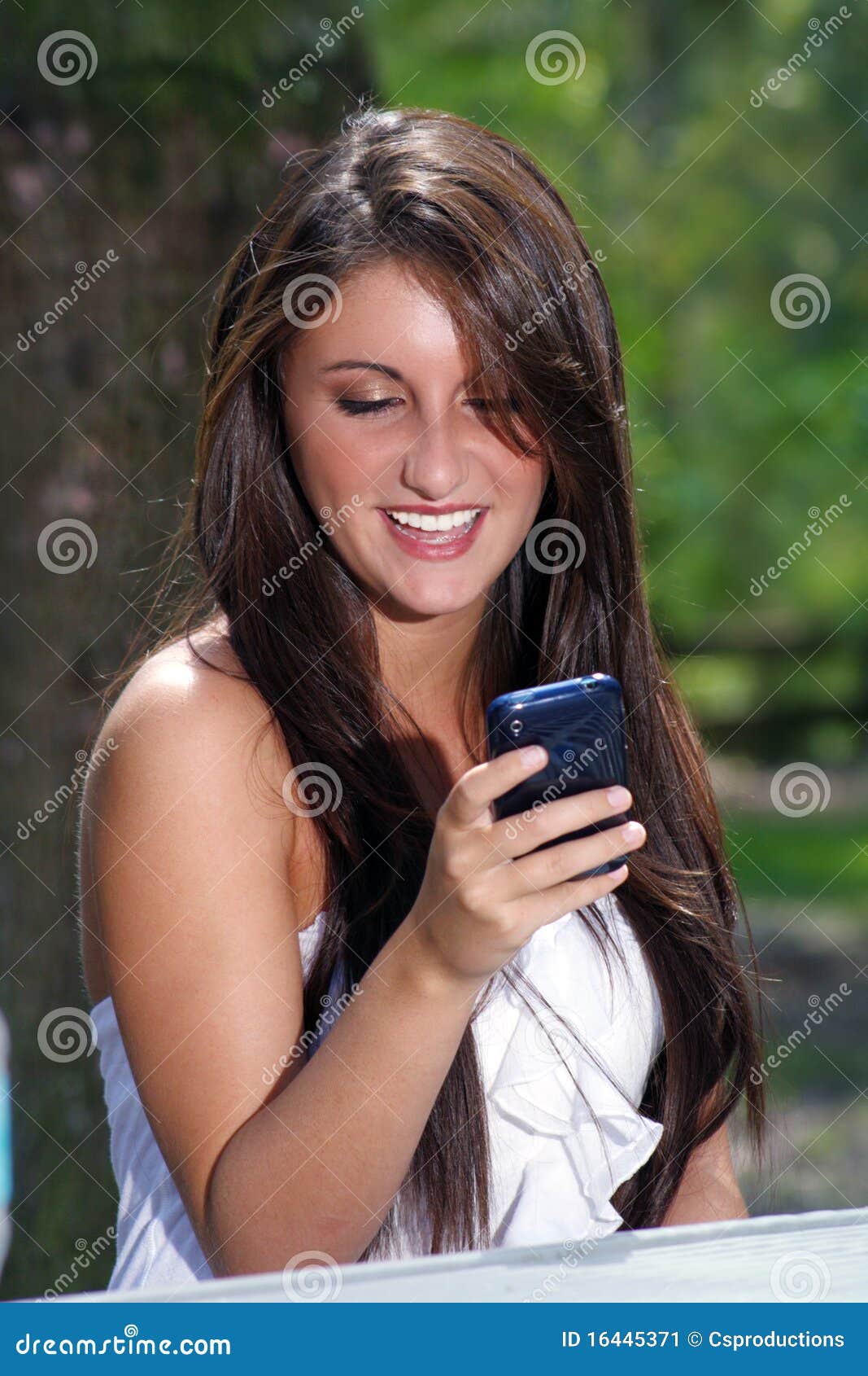 Beautiful Teen Brunette Texting Outdoors Stock Image