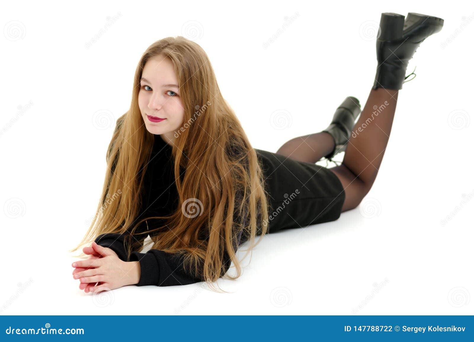 Teen Girl Lies in the Studio on a White Background. Stock Photo - Image ...