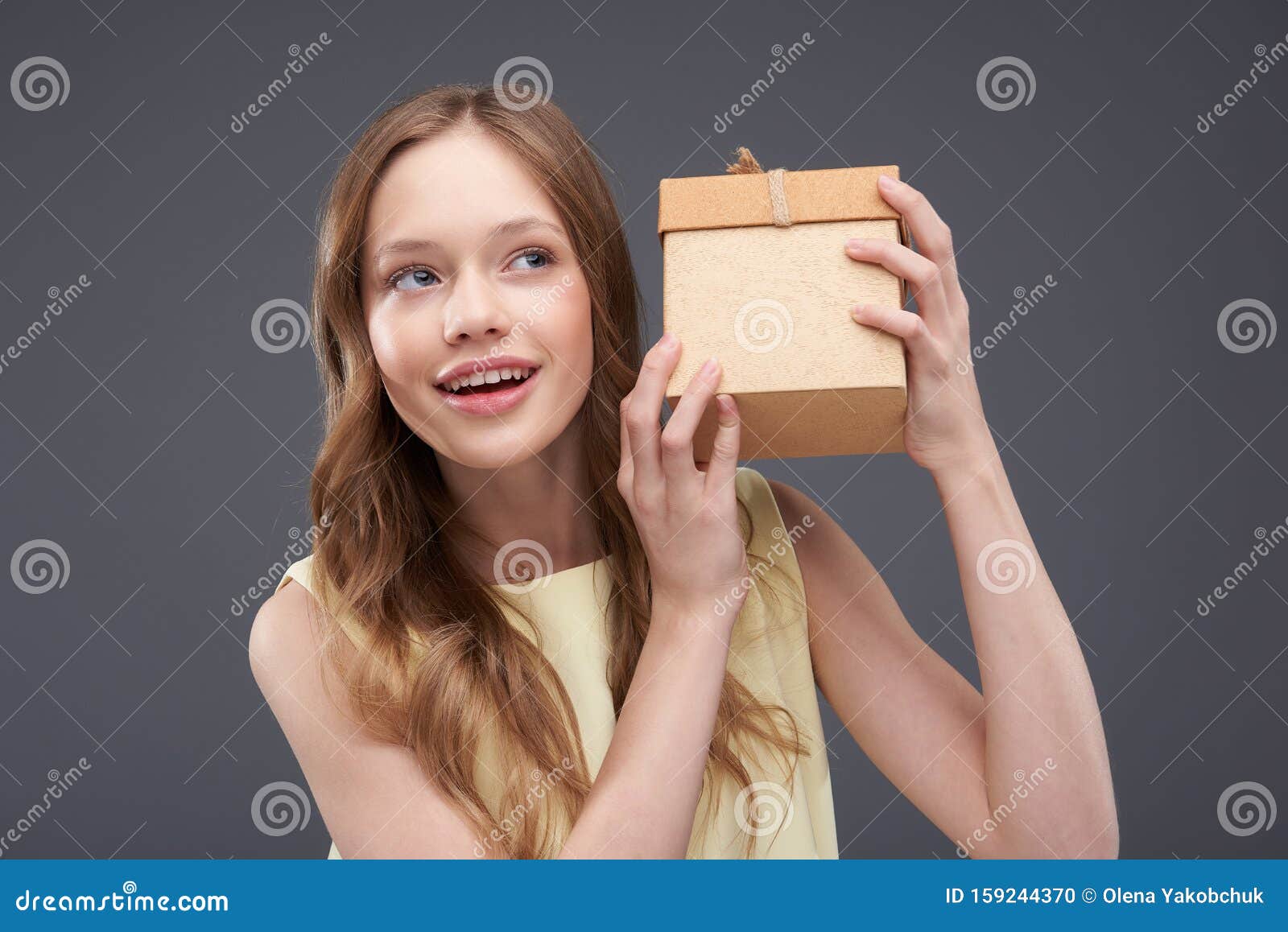 Beautiful Teen Girl Shaking Gift Box and Trying To Guess What Hidden ...