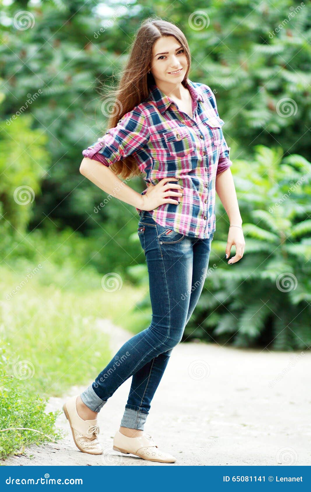 Cute teen girl choosing stylish jeans in clothing store Stock Photo - Alamy