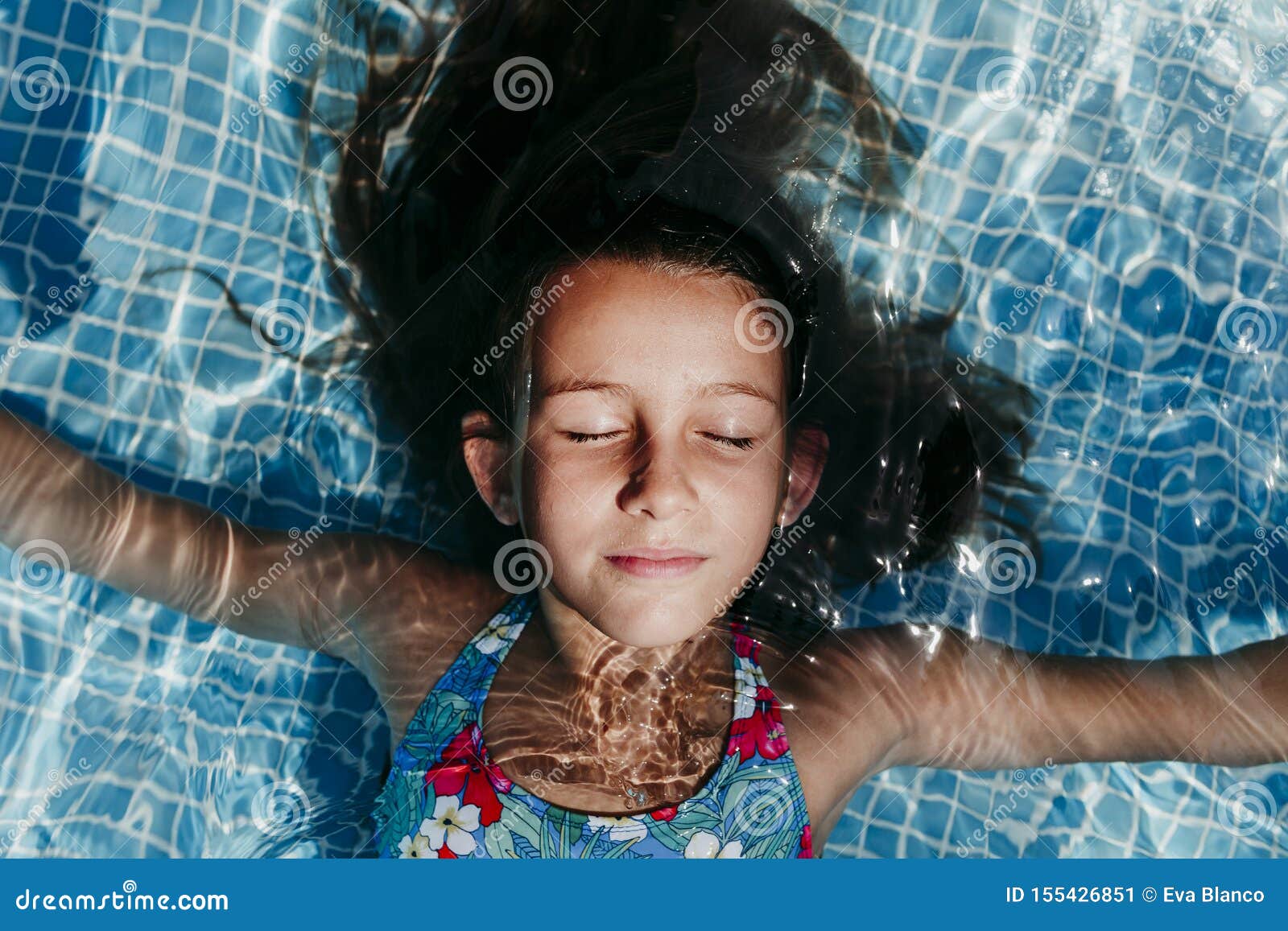 Beautiful Teenager Girl Floating in a Pool and Looking at the Camera ...