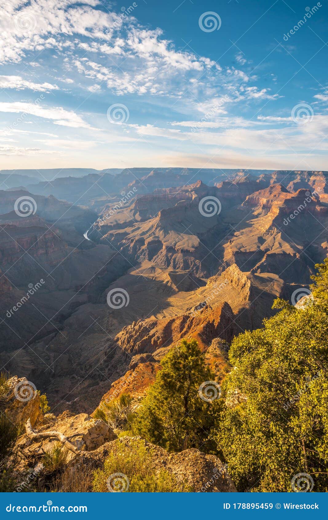 Beautiful Vertical Shot Of Landscape Of The Grand Canyon Under A Blue