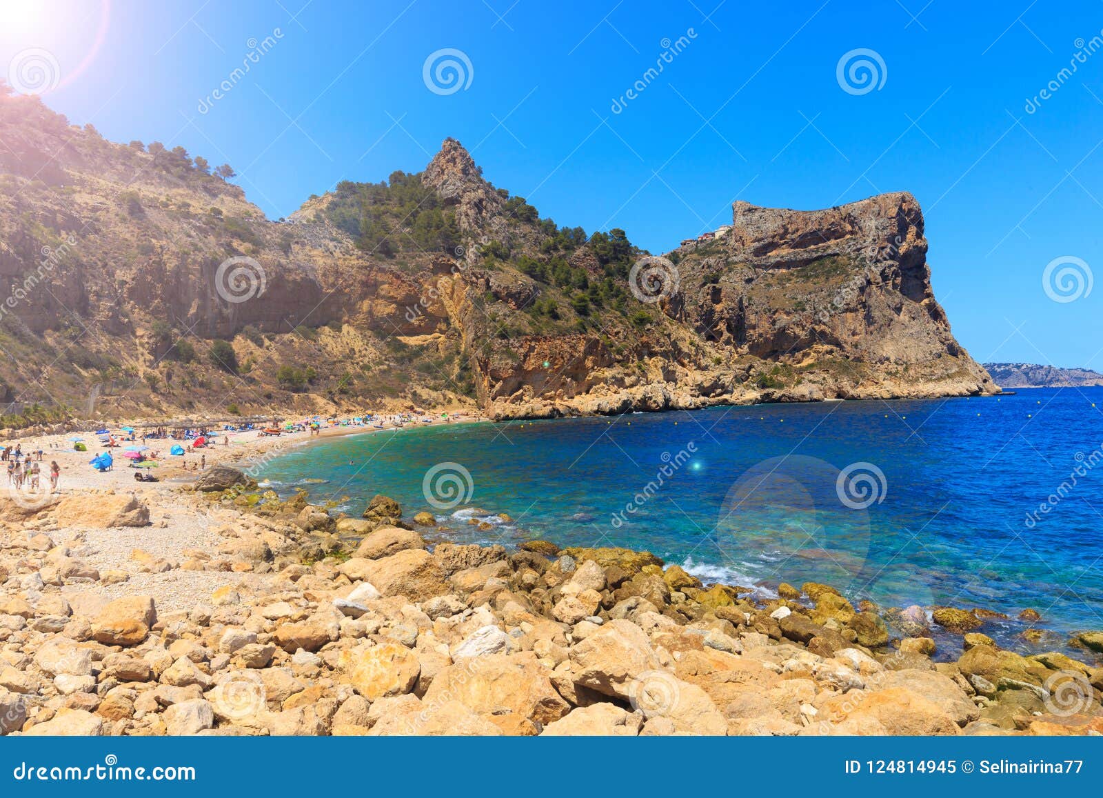 beautiful view of beach in a bay with turquoise water in the sun, la playa moraig in cumbre del sol, spain.