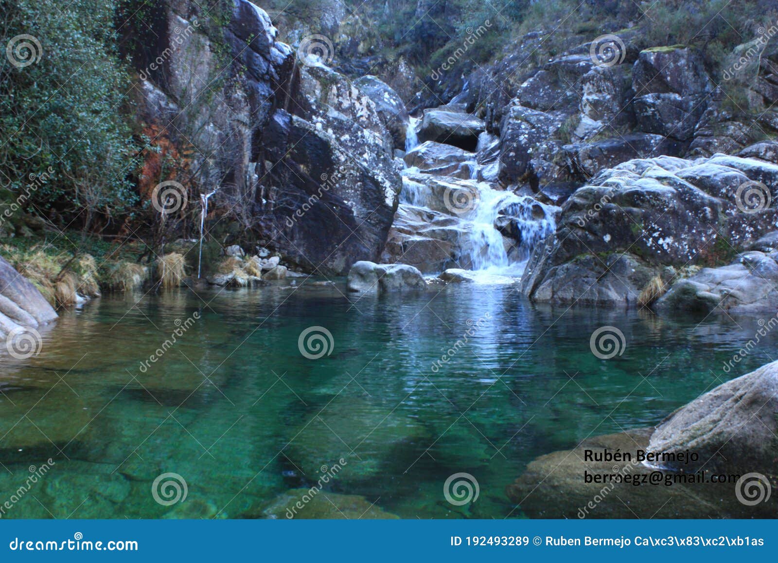 beautiful view of a crystal clear water natural pool with the turquoise green background and rocks. corga de fecha, lobios