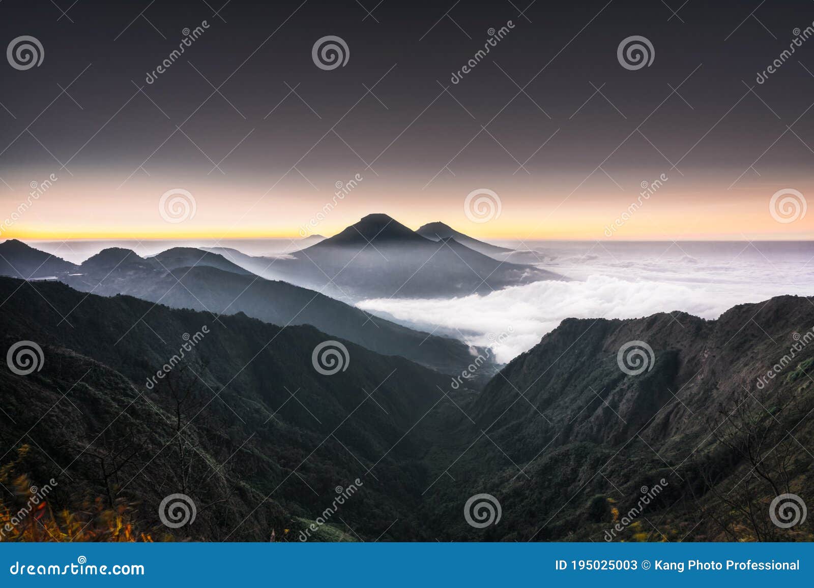 beautiful view fog covers mount sindoro sumbing. view from the top of bismo hill when golden hours