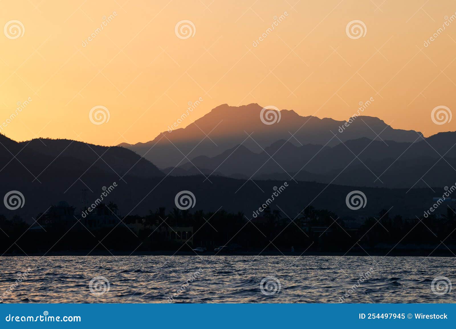 beautiful view of an ocean with mountains in the background at scenic sunset in loreto, mexico