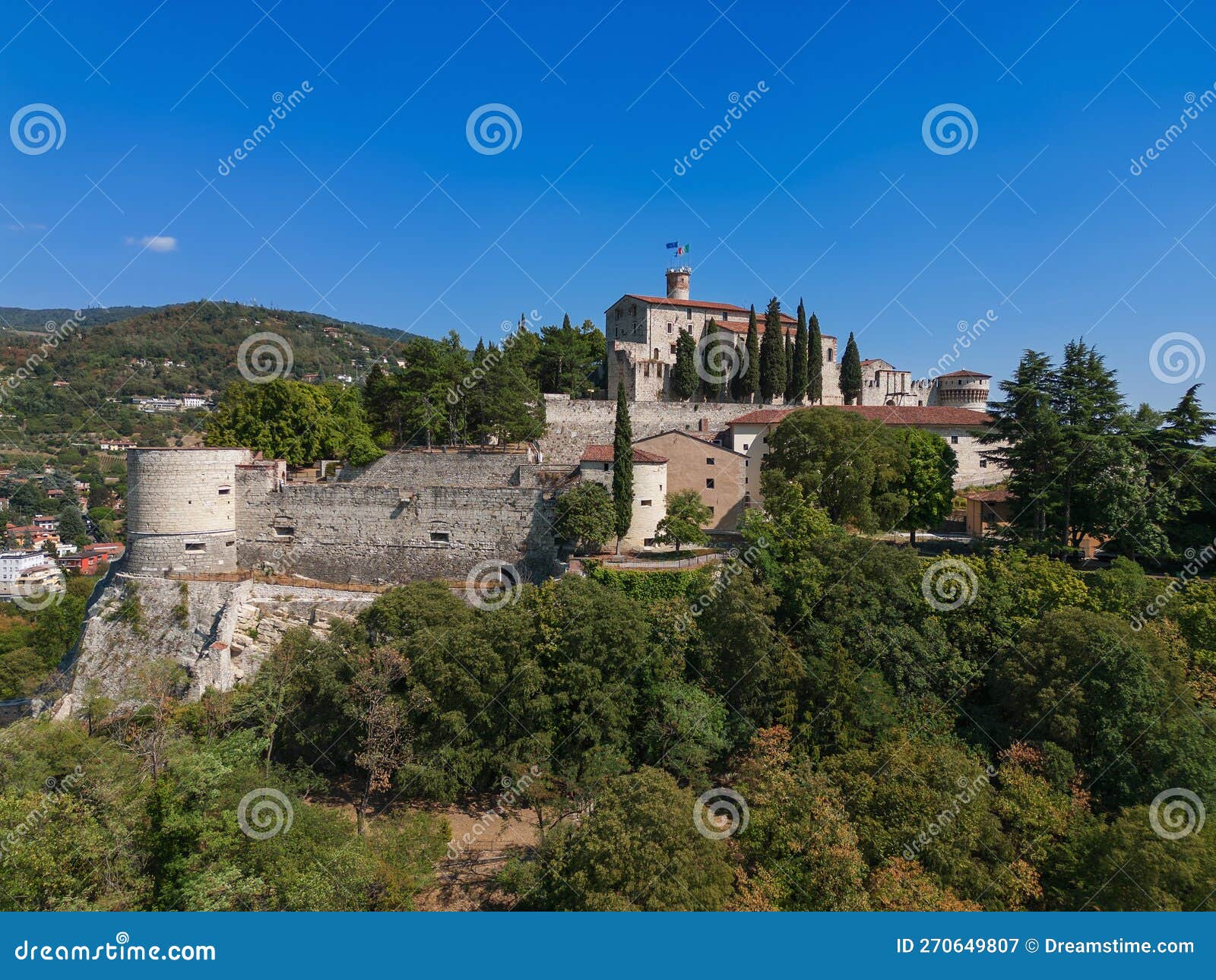 beautiful view of the old park and the hill (colle cidneo) with the historic castle on it in brescia town