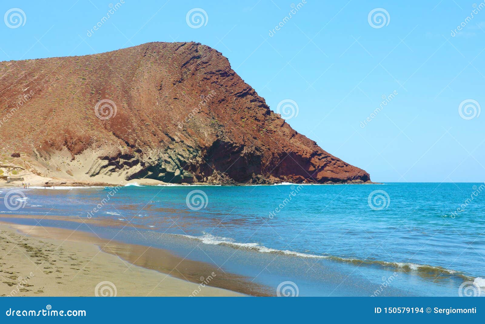 beautiful view of playa de la tejita with montana roja red mountain. la tejita beach in el medano, tenerife, canary islands,