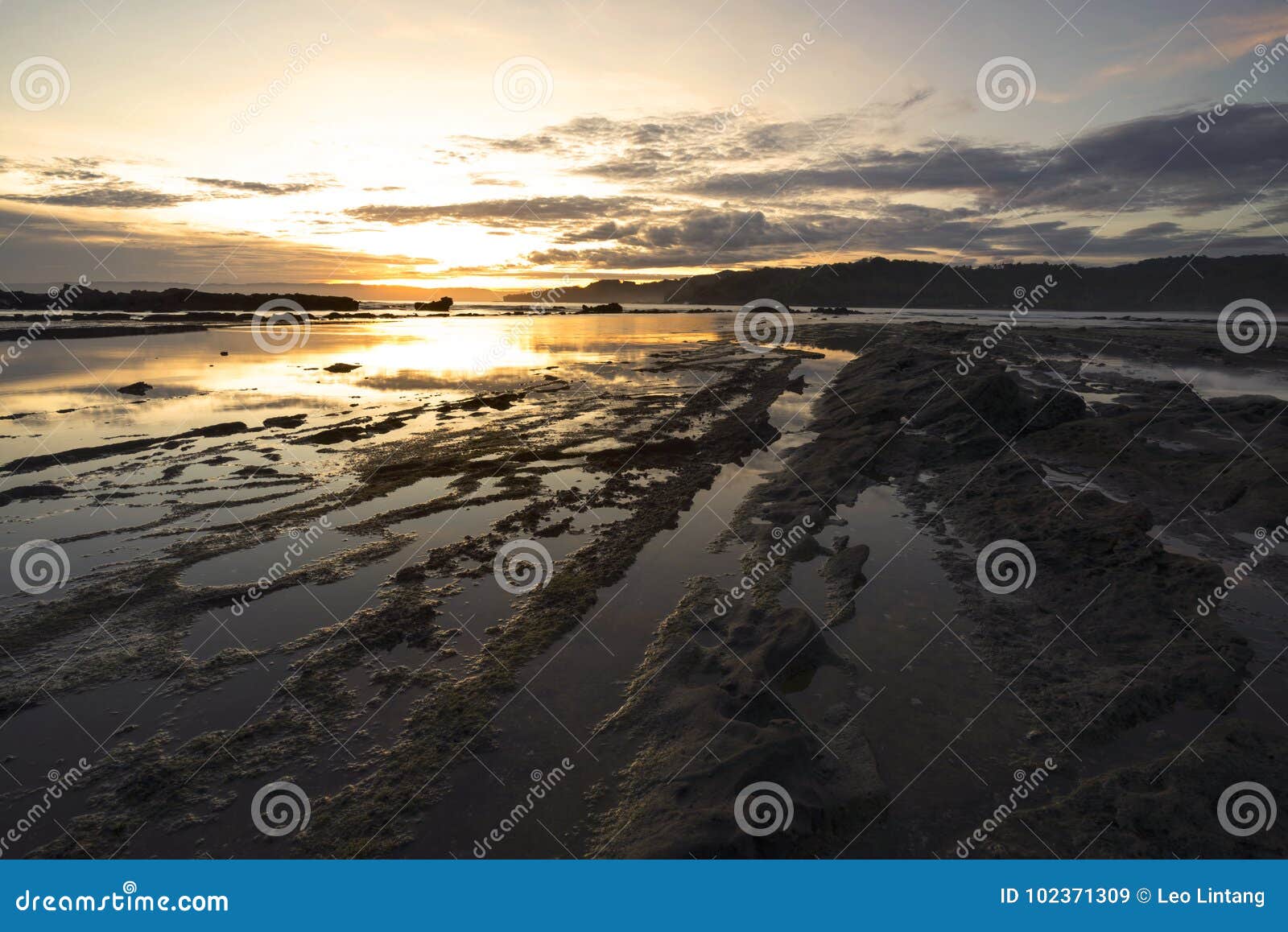 beautiful view of sawarna beach with rocks and calm waves