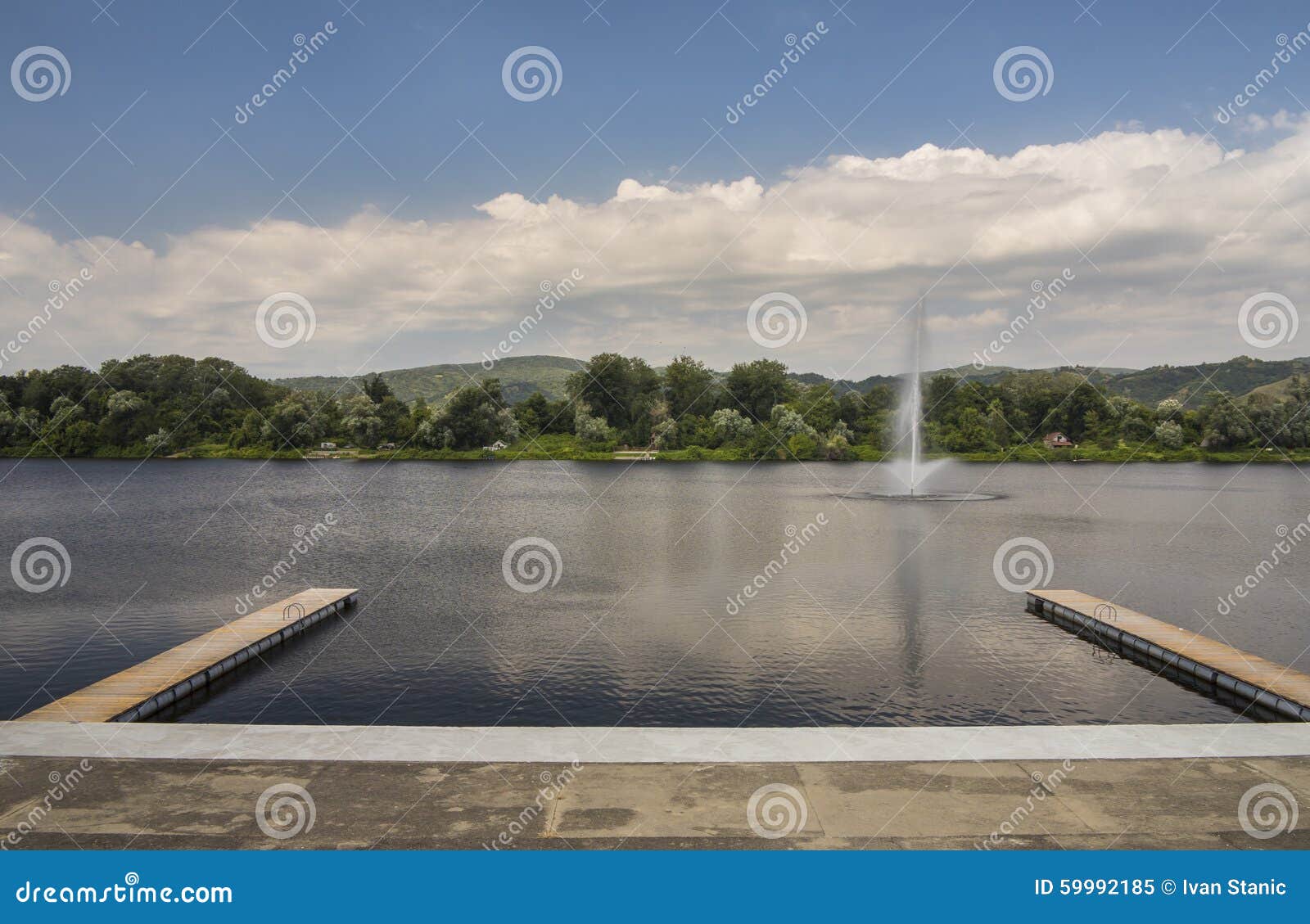 beautiful view of silver lake with two wooden piers and fountain