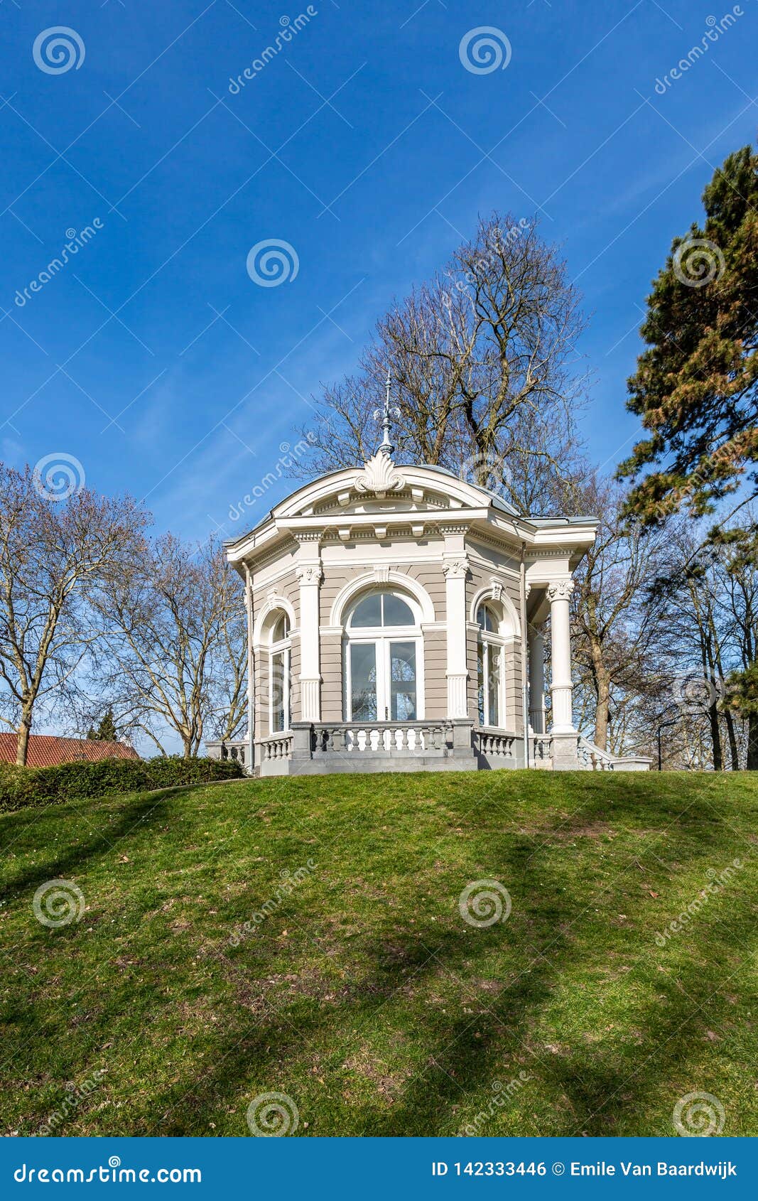 beautiful view of the tea dome or gloriette on a hill with green grass