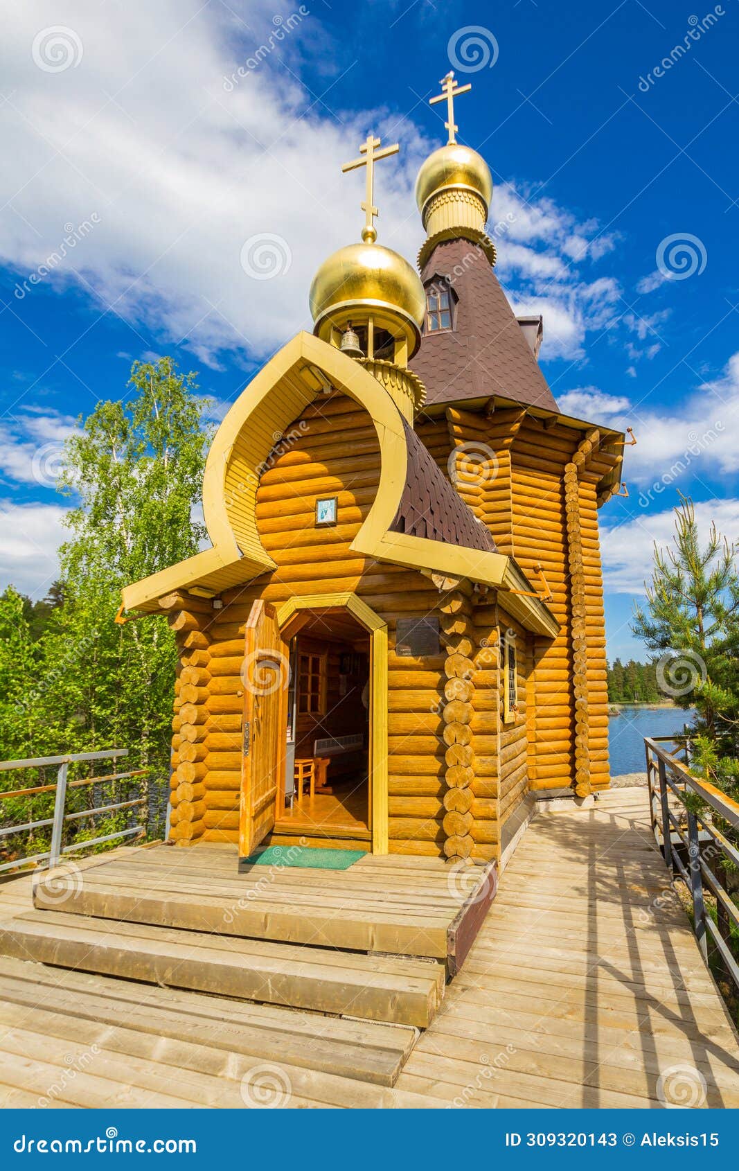 beautiful view to wooden church of st. apostle andrew first-called on vuoksa river with bridge. temple on small island
