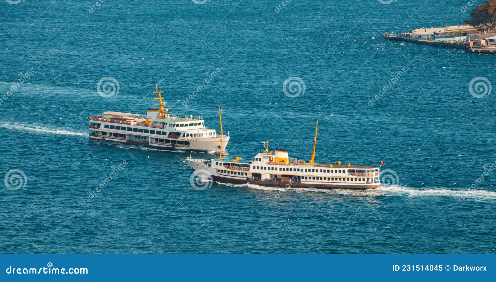 beautiful view of two passenger ferry sailing in the sea and people fishing on a dock in zeytinburnu district