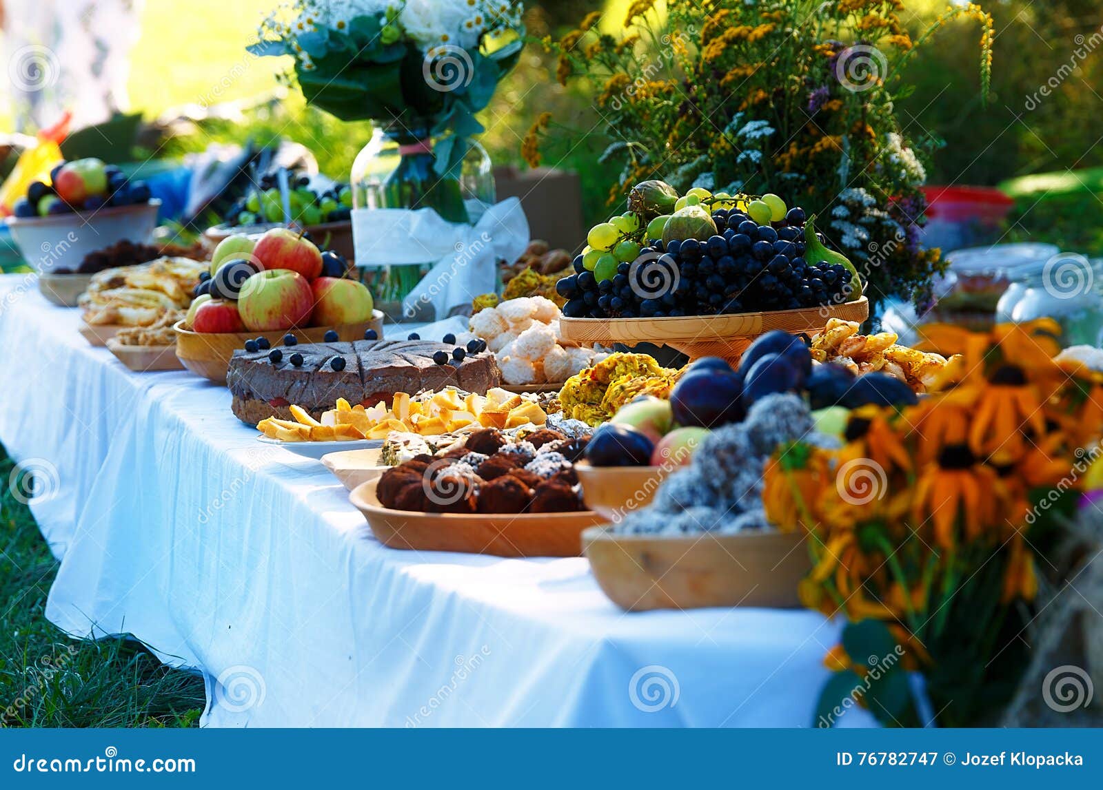 beautiful wedding feast in nature, abundance of meals on a table.