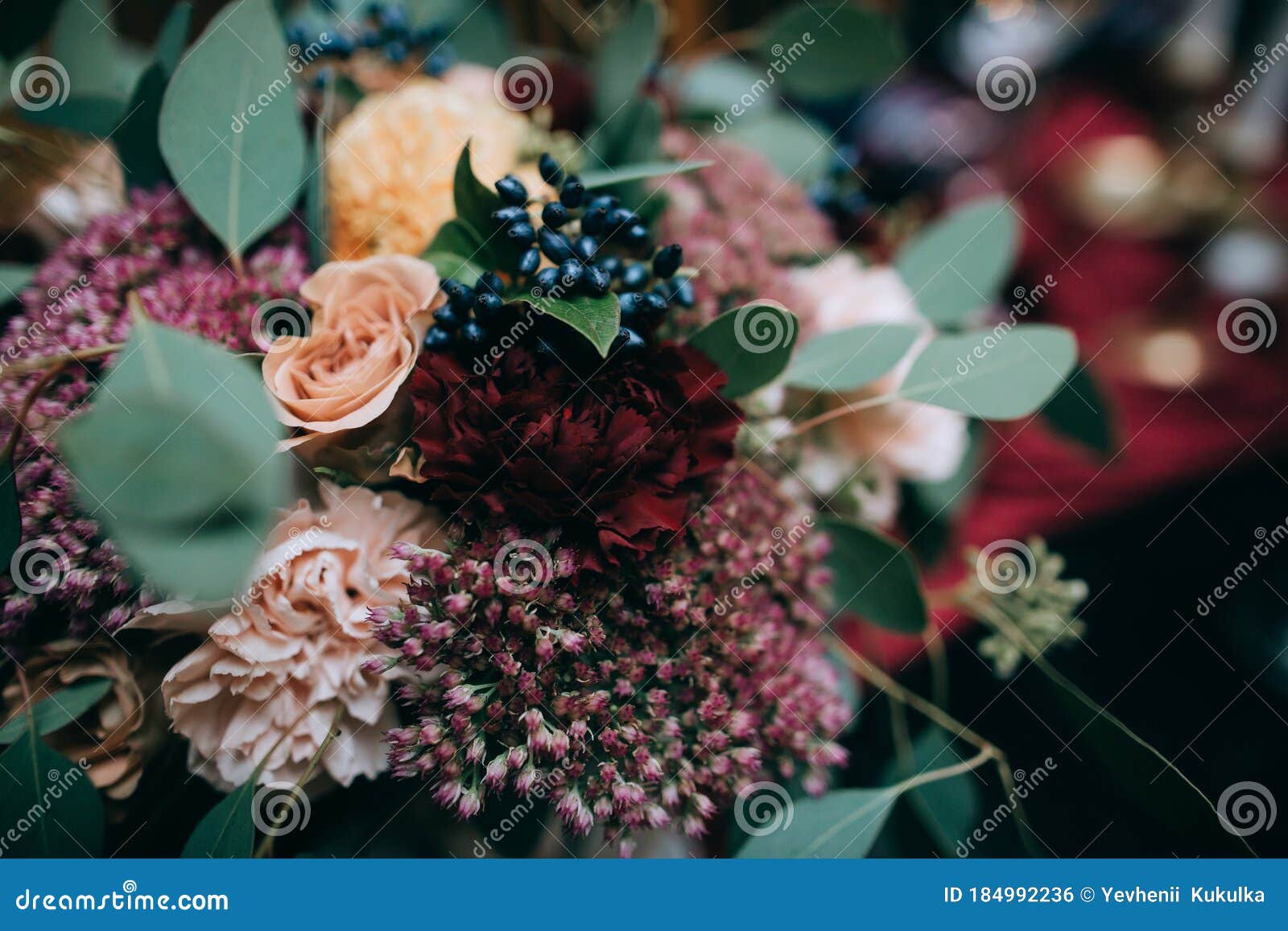 beautiful weding table decoration with red fresh flowers and candles