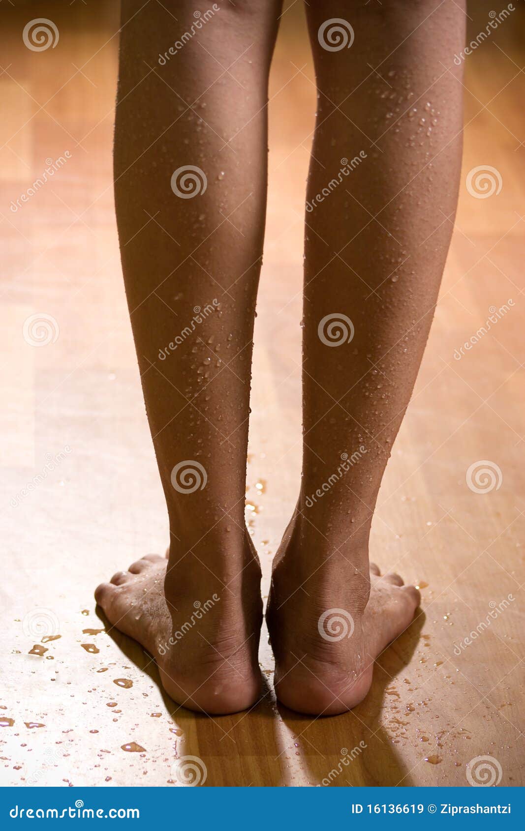 Beautiful And Wet Female Legs On Wooden Floor Royalty Free Stock Images