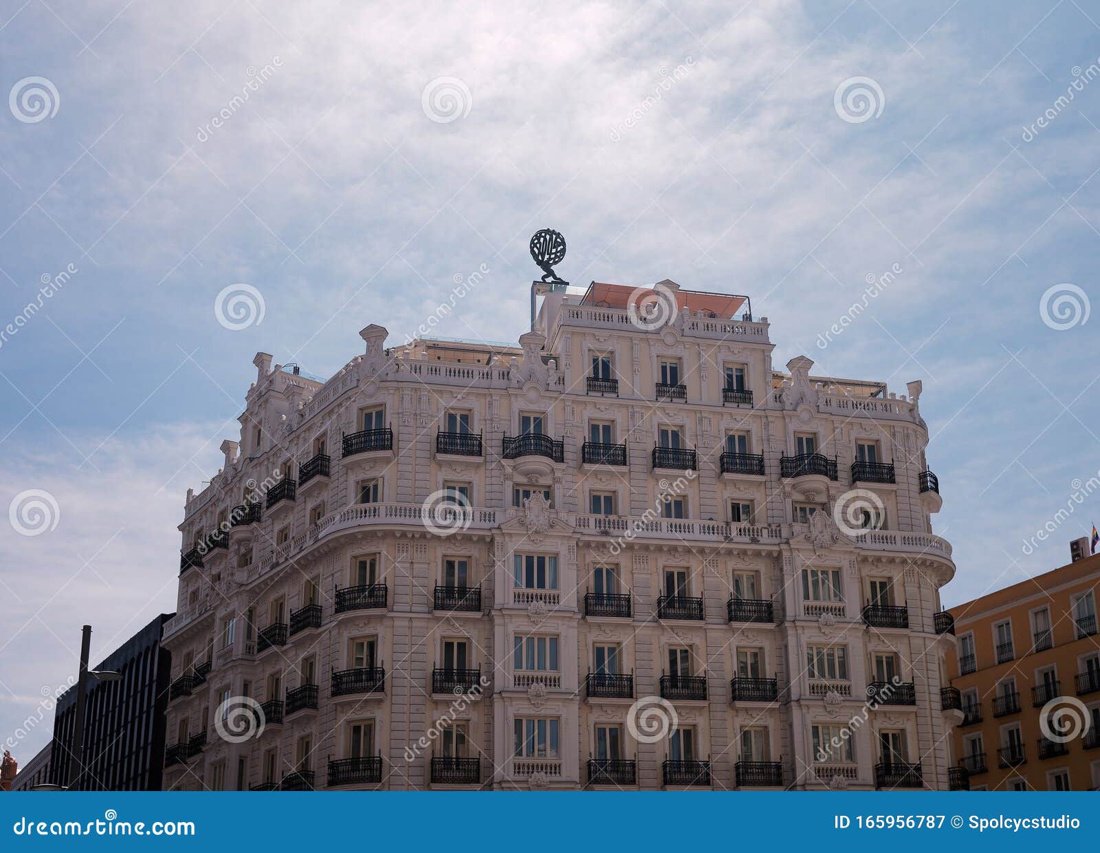 beautiful white building against blue sky at calle gran via, madrid, spain