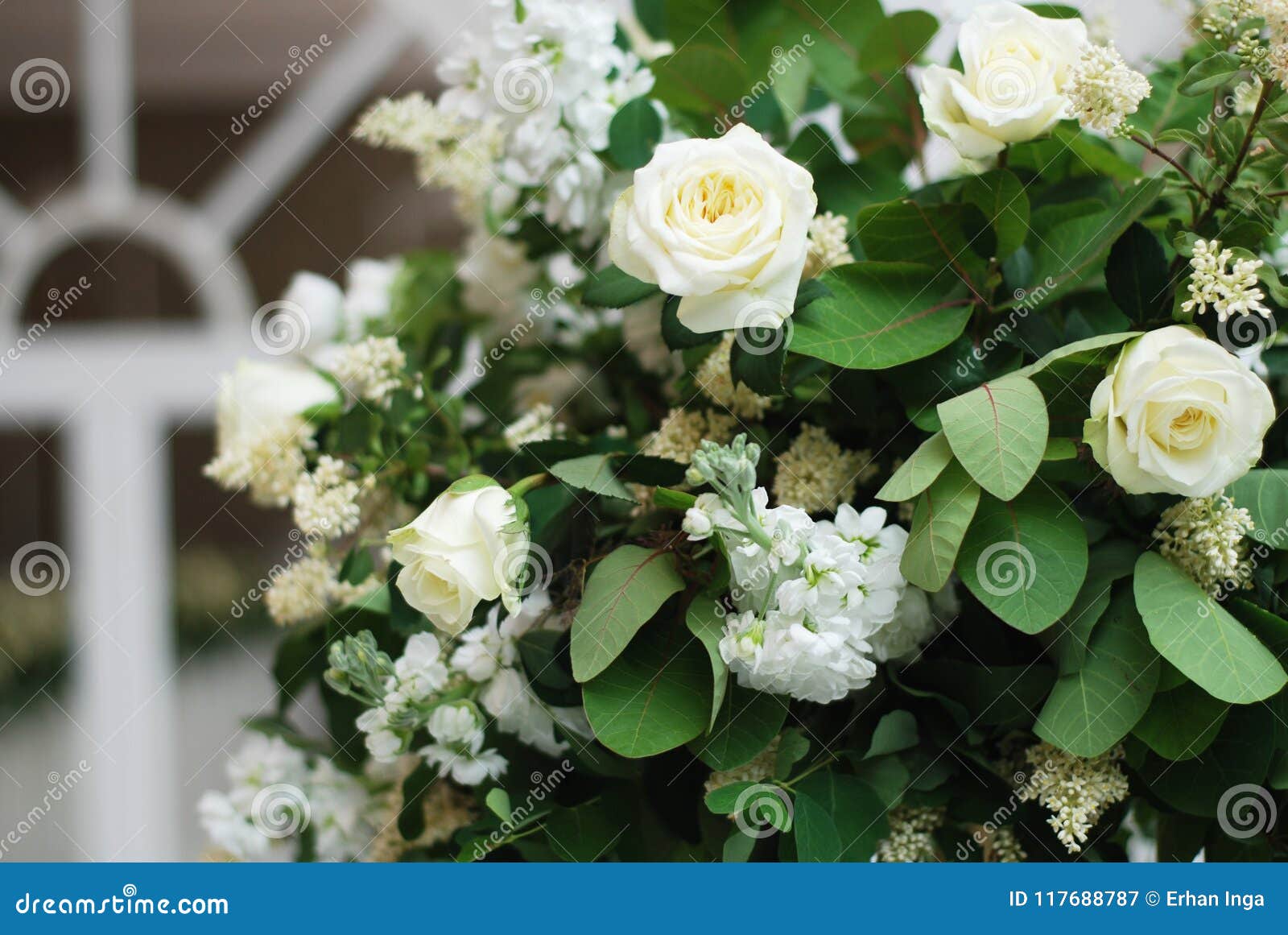 beautiful white and green flower decoration arrangement on wedding table golden support . wedding bridal flower decoration.