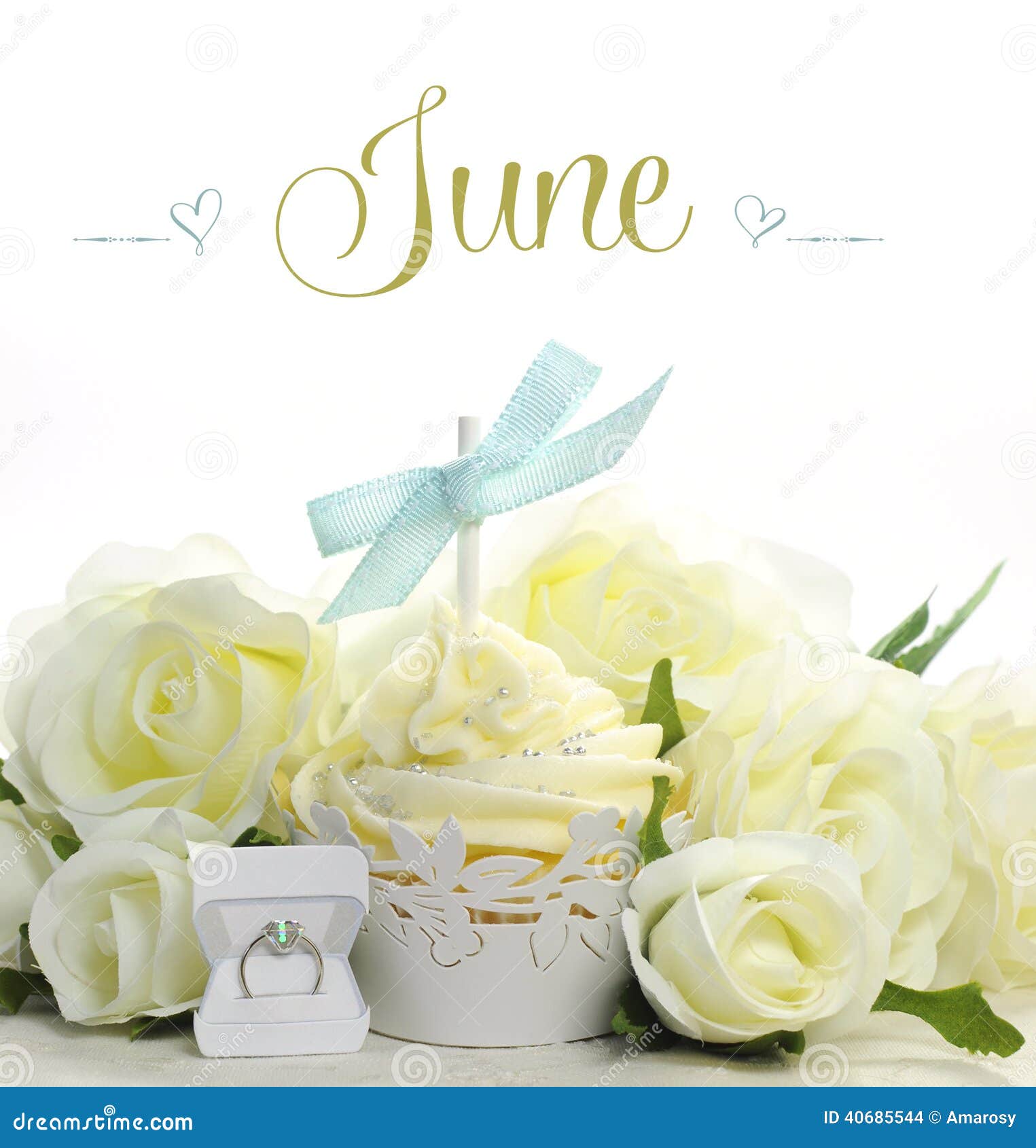 beautiful white june bride theme cupcake with seasonal flowers and decorations for the month of june