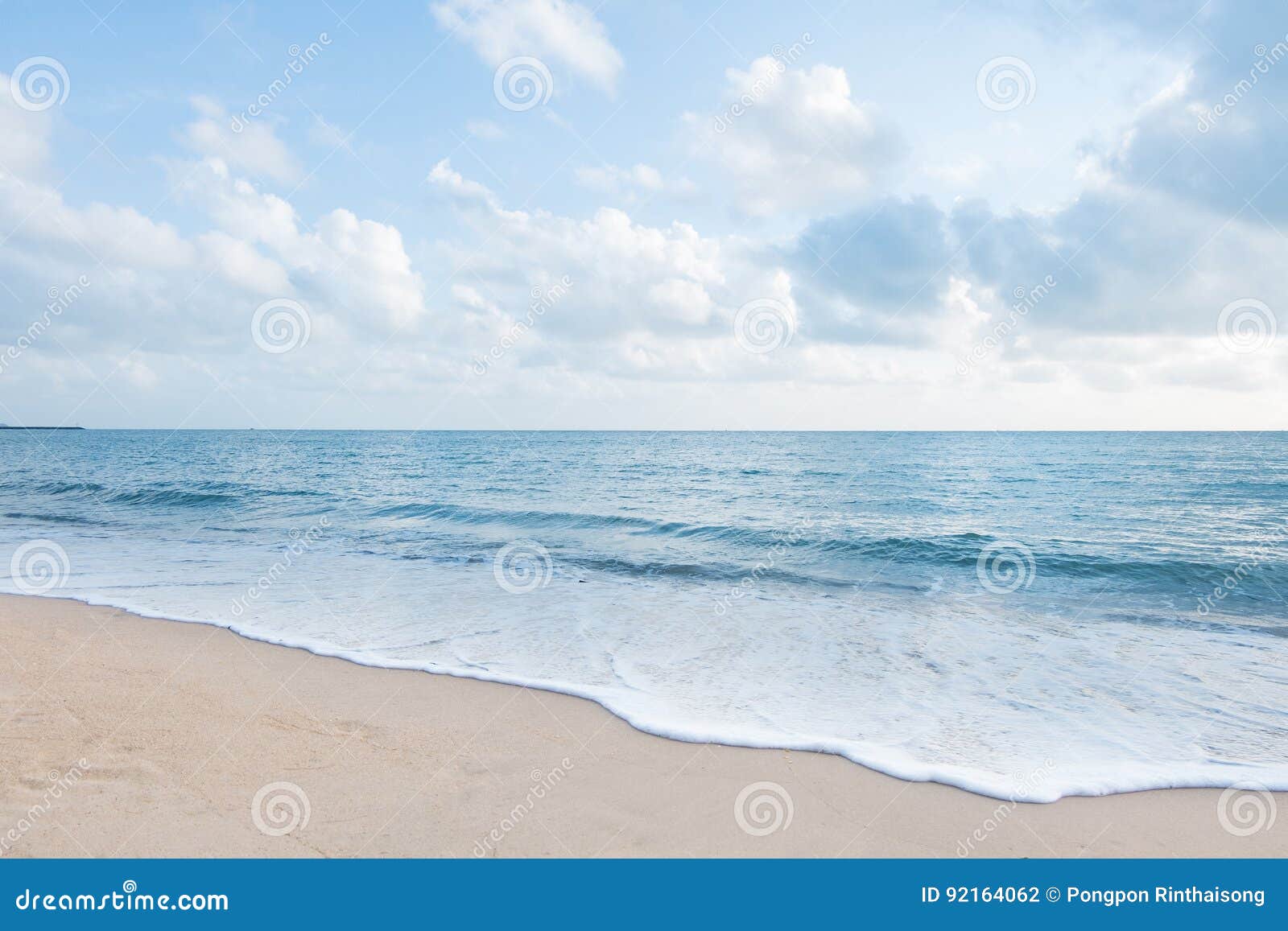 beautiful white sand beach and ocean waves with clear blue sky