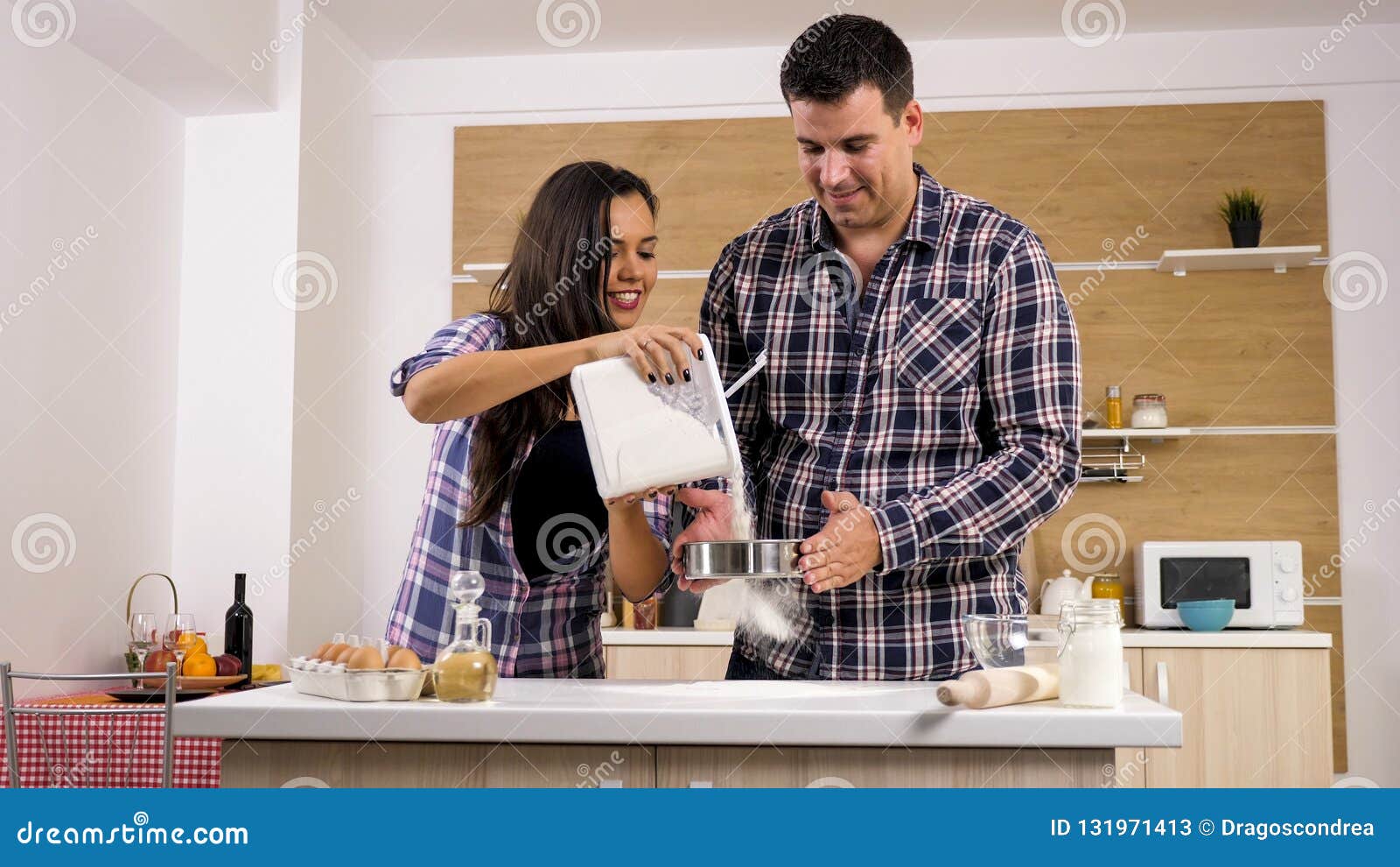 Beautiful Wife Helps Her Husband While He Cooks For Her Stock Image