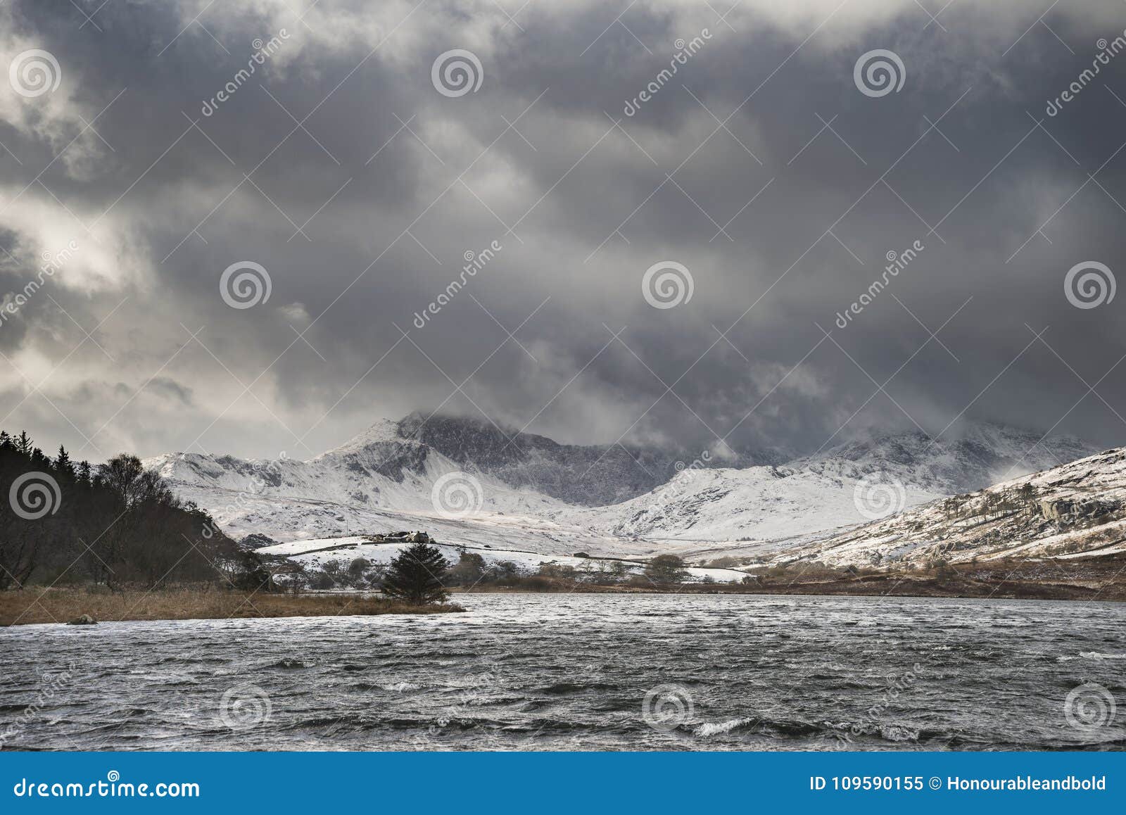 beautiful winter landscape image of llynnau mymbyr in snowdonia
