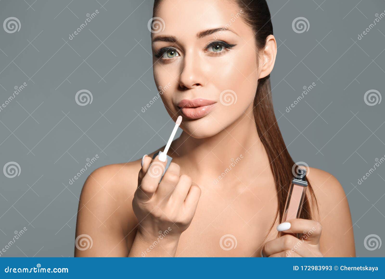 Beautiful Woman Applying Lip Gloss On Grey Background Stylish Makeup Stock Image Image Of