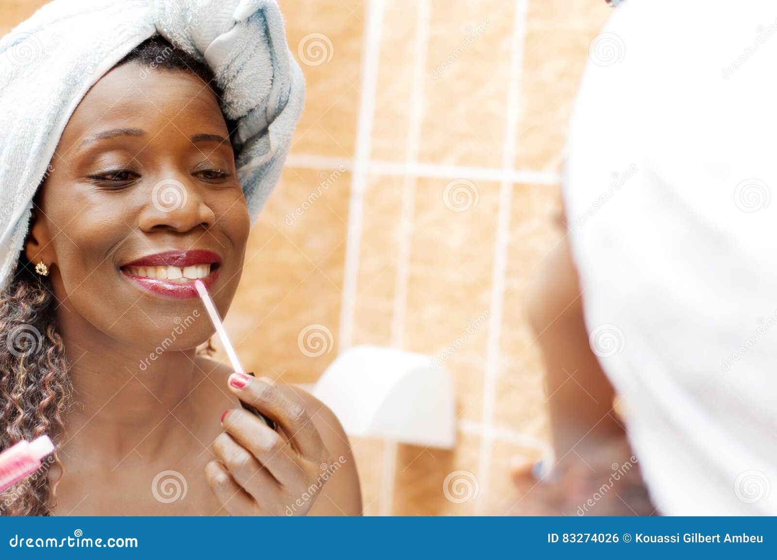 Beautiful Woman Applying Makeup in the Bathroom. Stock Photo Image of
