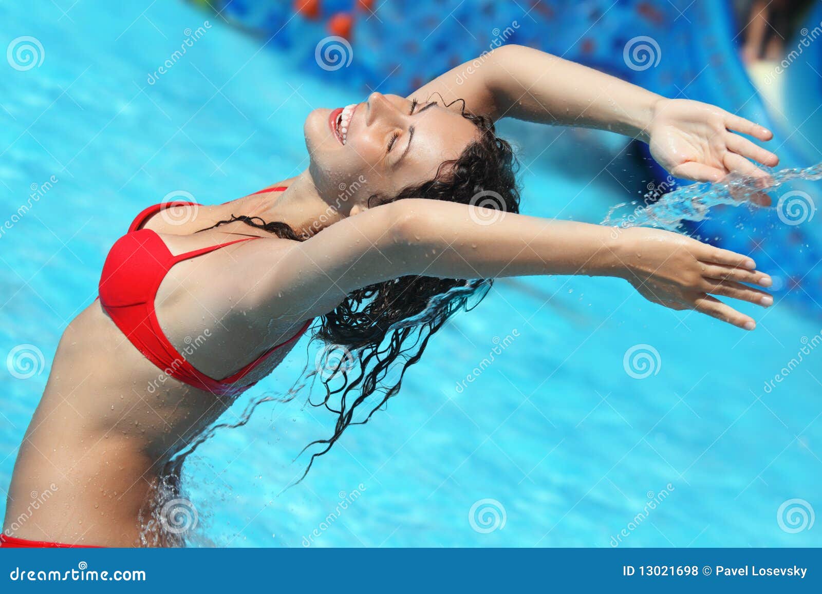 Beautiful Woman Bathes in Pool Under Water Stream Stock Photo