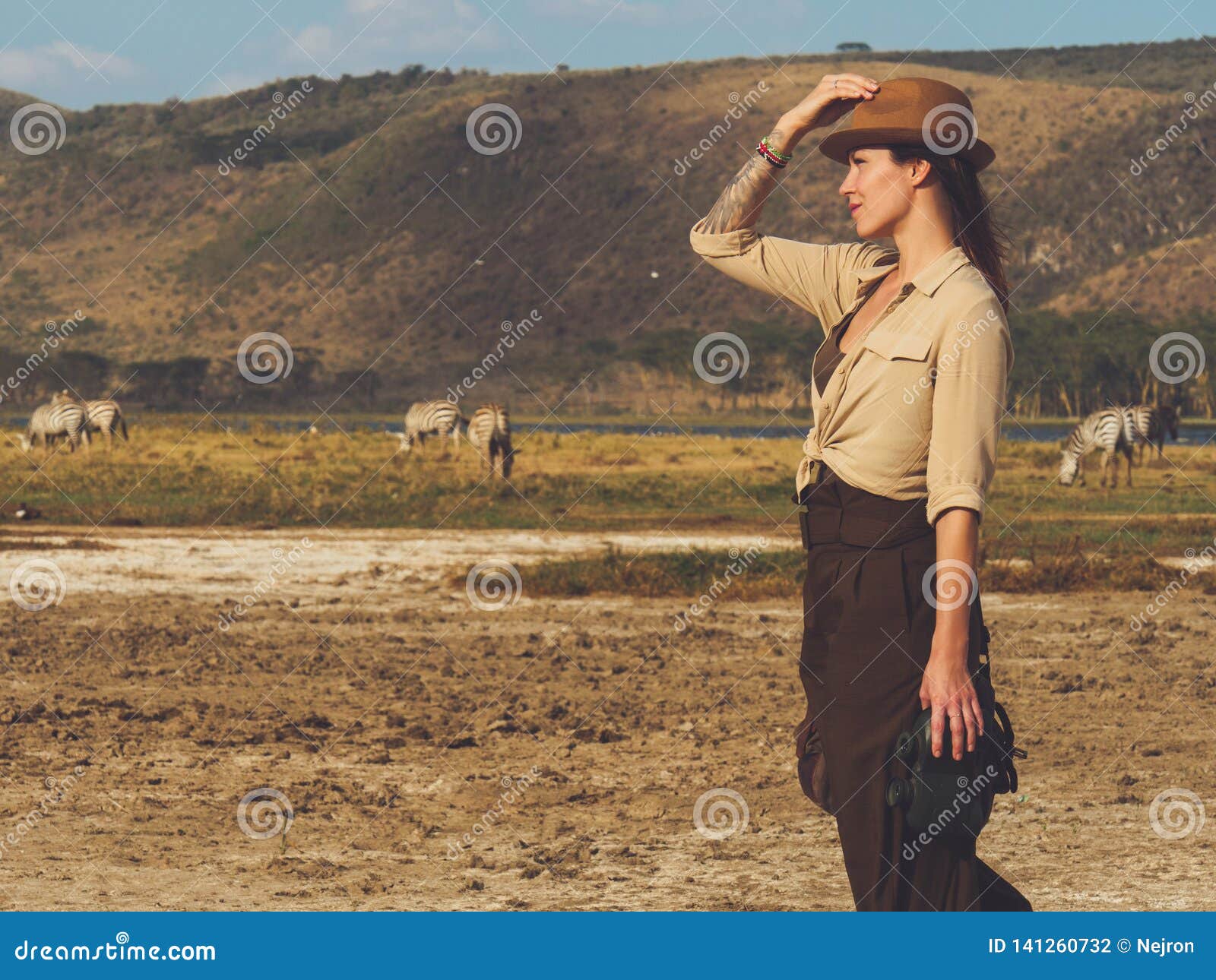 Beautiful Woman with Binoculars at Savanna in Kenya Stock Photo Image