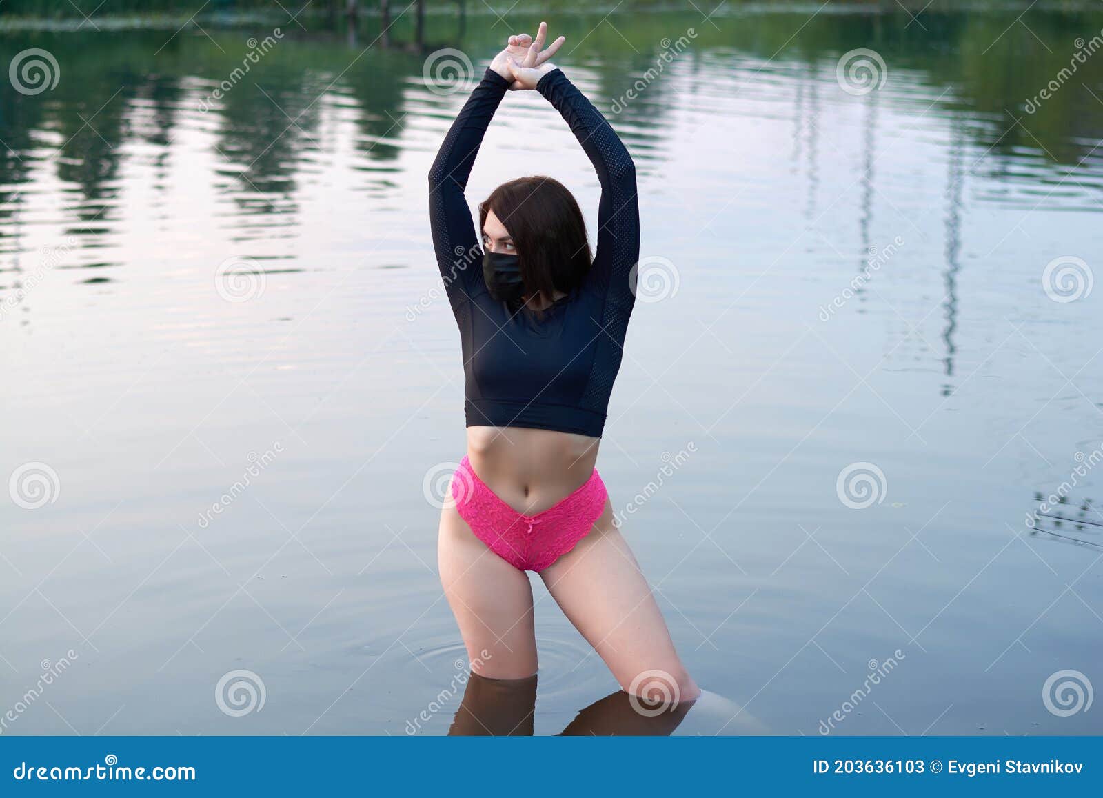 A Beautiful Woman In A Black Medical Mask Stands In The River Rest In The Pandemic Stock Image
