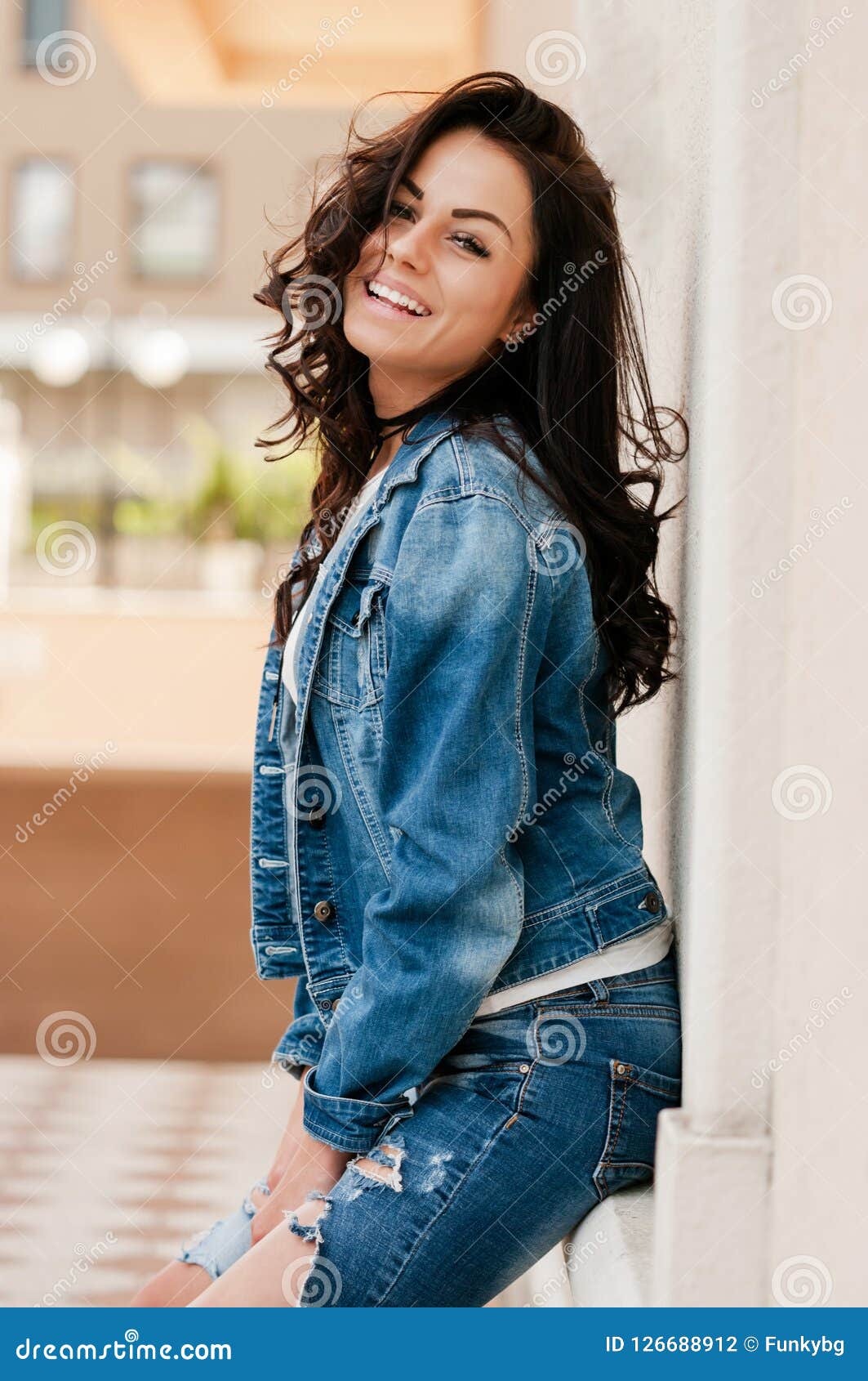 Woman with Brown Hair in Denim Jacket Posing on Camera Stock Photo ...