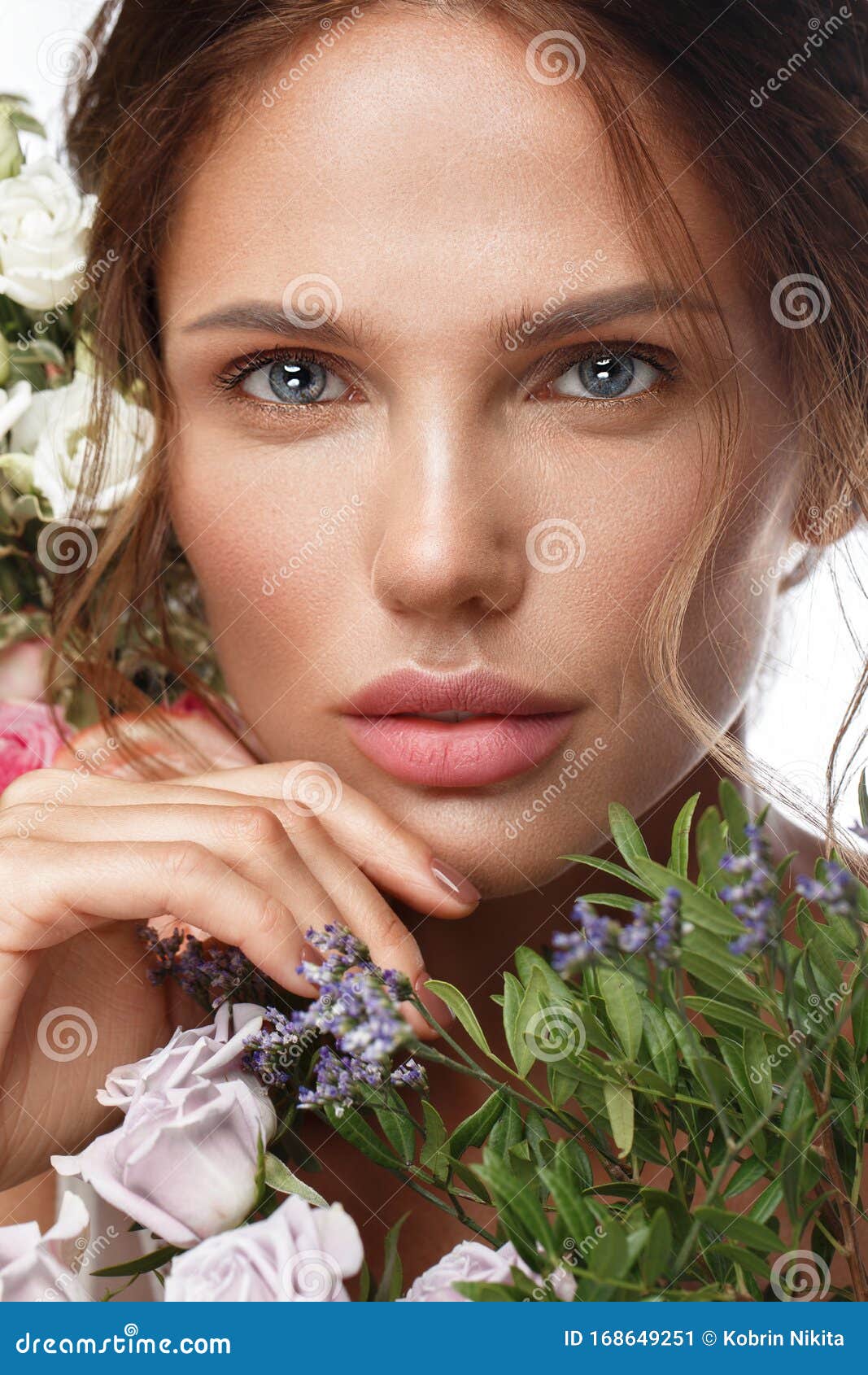 Beautiful Woman With Classic Nude Make Up Light Hairstyle And Flowers