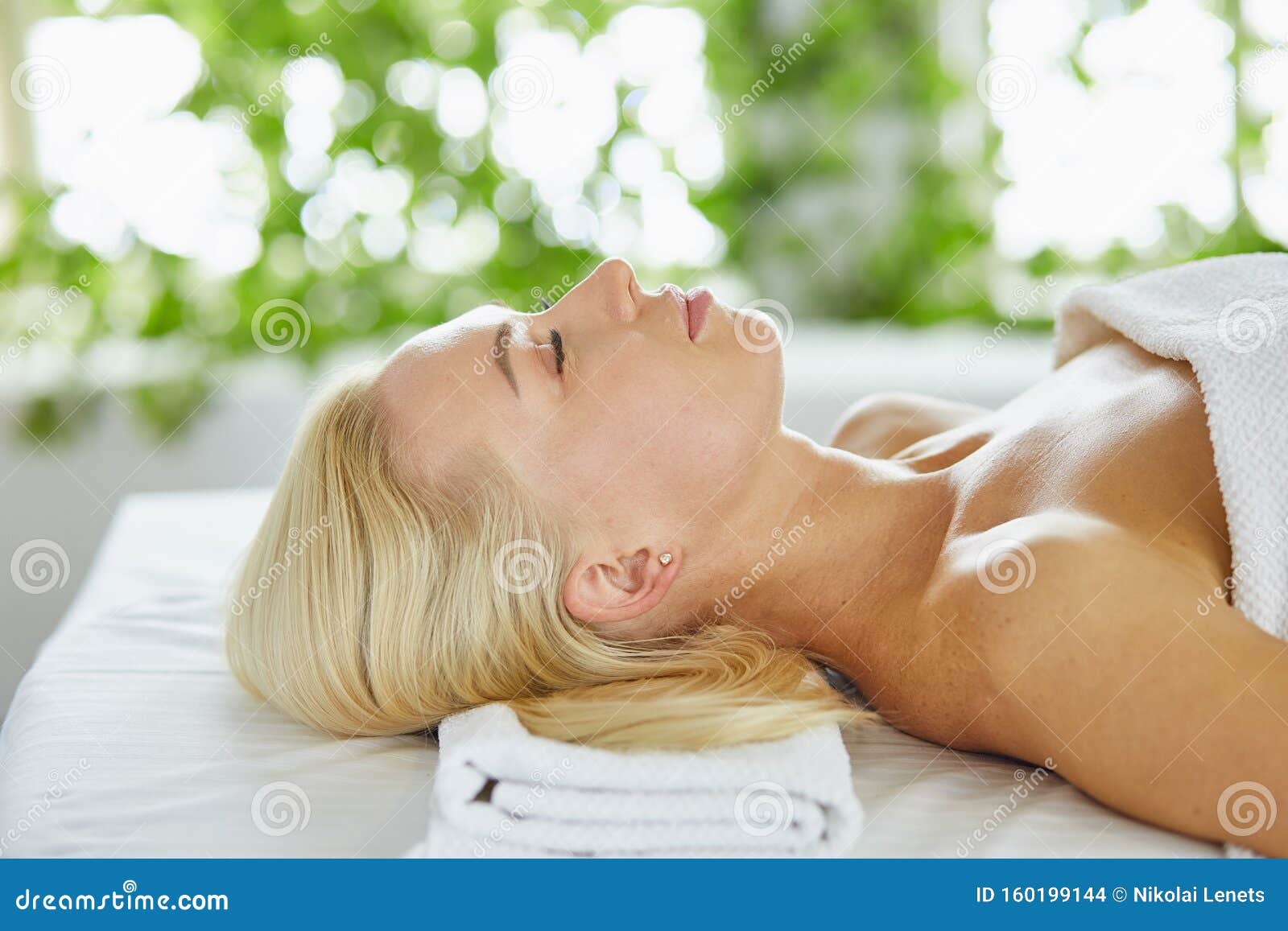 Beautiful Woman With Closed Eyes Getting A Massage In The Spa Salon