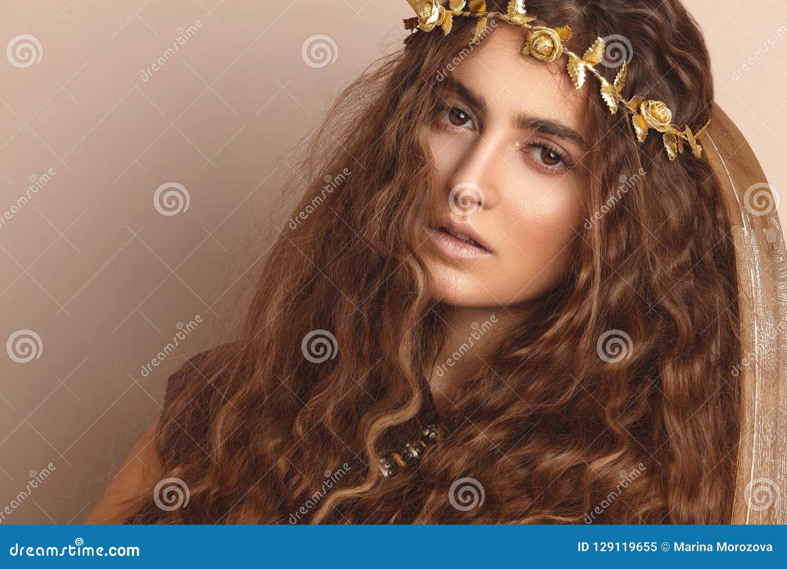 beautiful woman. curly long hair. fashion model. healthy wavy hairstyle. accessories. autumn wreath, gold floral crown