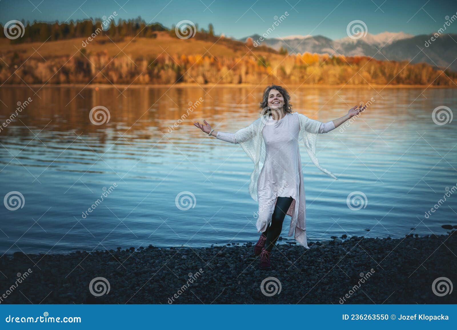 Beautiful Woman Dancing in Nature at Sunset. Stock Photo Image of