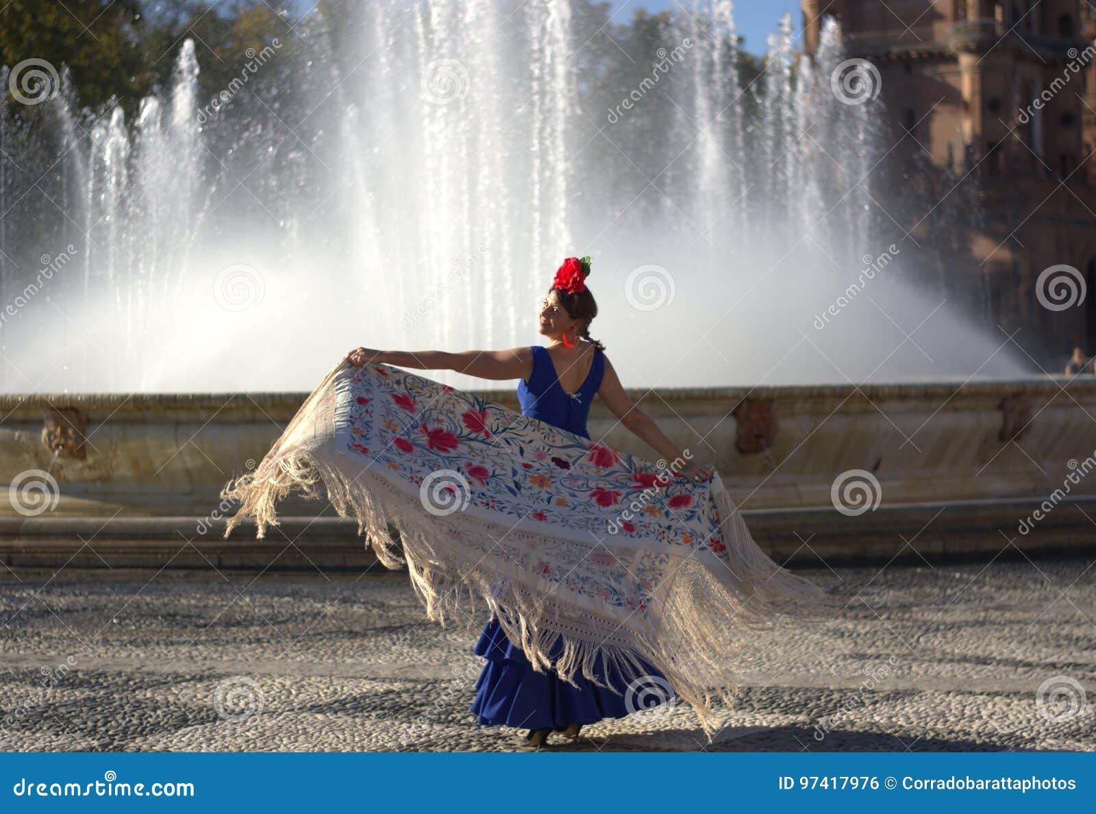 the beautiful woman dancing near the water of the fountain